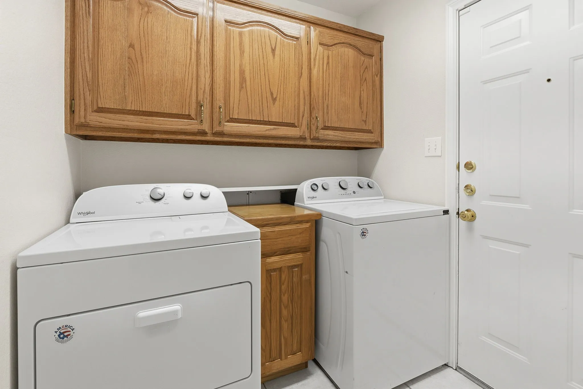 Utility with custom cabinets and extra pantry.