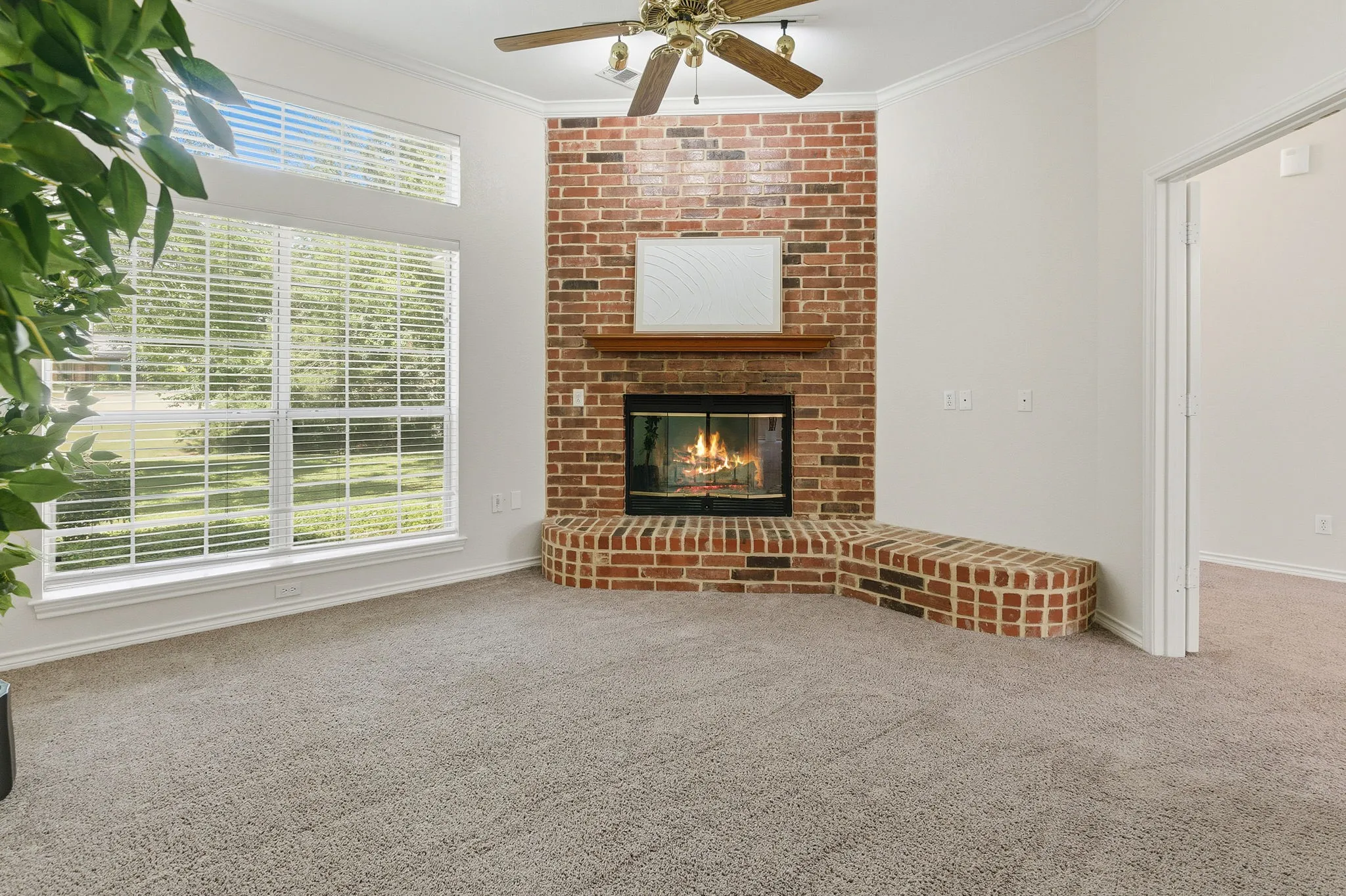 Bedroom offers French doors, a red brick wood-burning fireplace with blower, and wonderful flexibility as a bedroom, office, den, library, or additional living area.