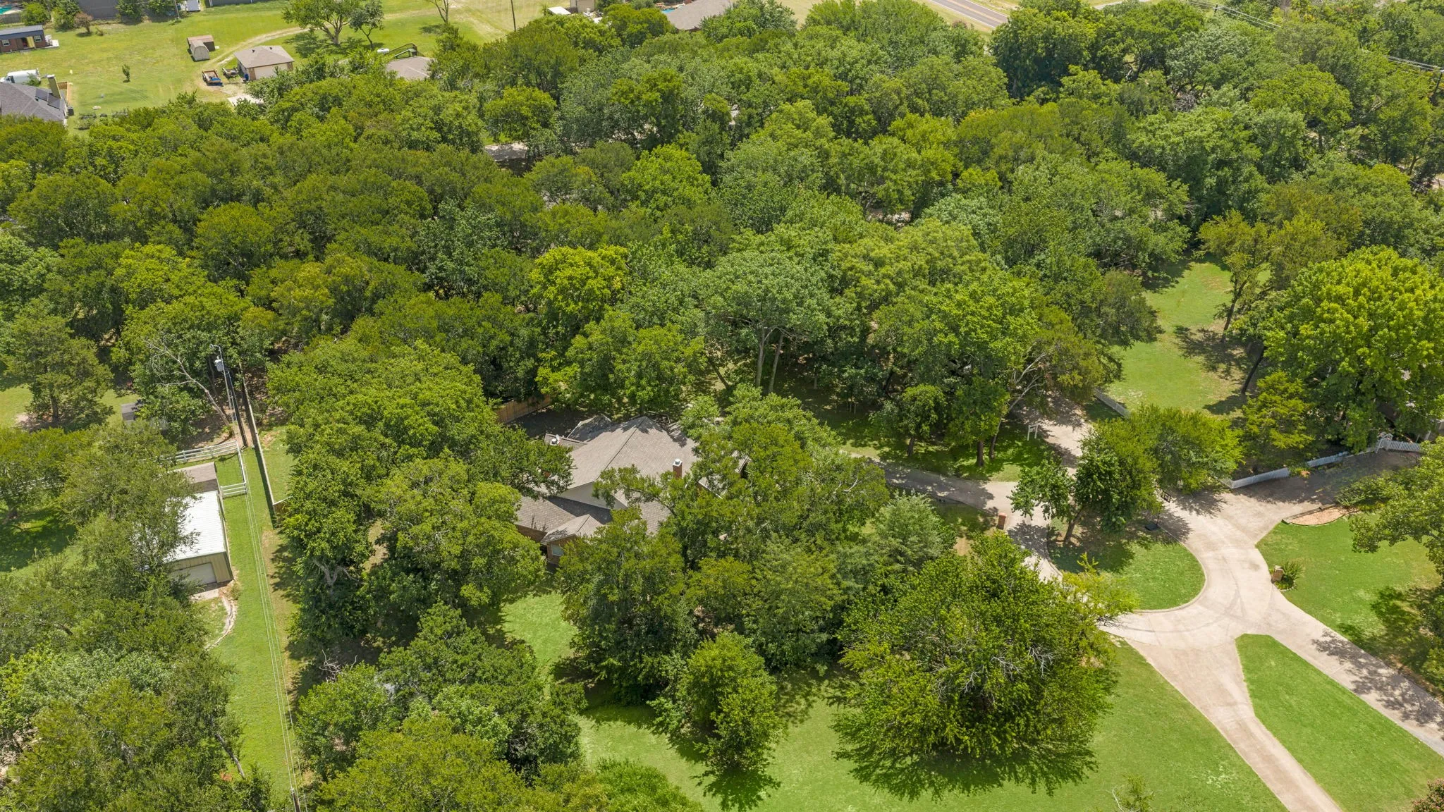 Tucked beneath a canopy of mature trees, this property offers the feel of country living with room to breathe, while still being about 10 minutes from Downtown McKinney