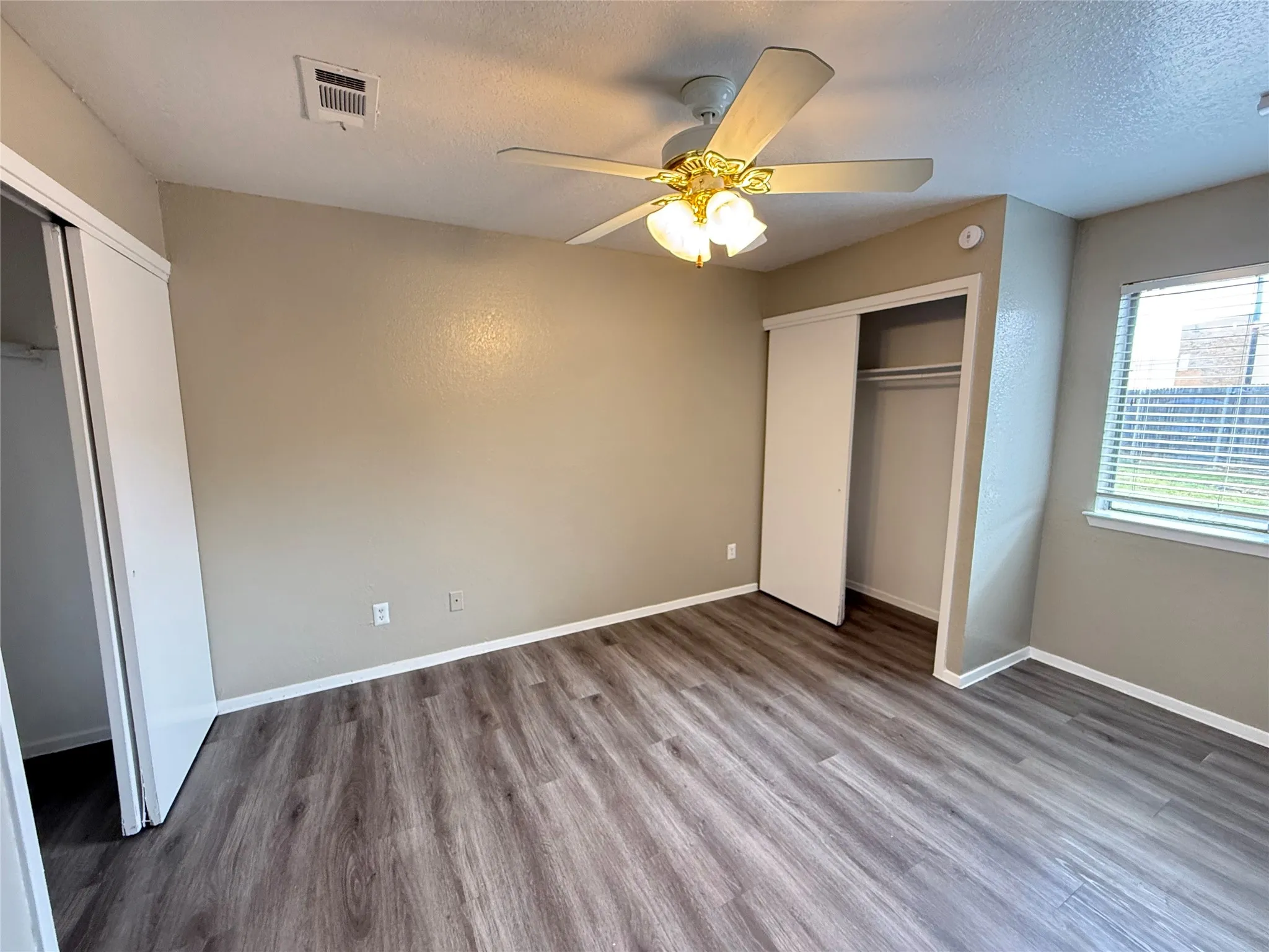 Primary suite with his and hers closets.