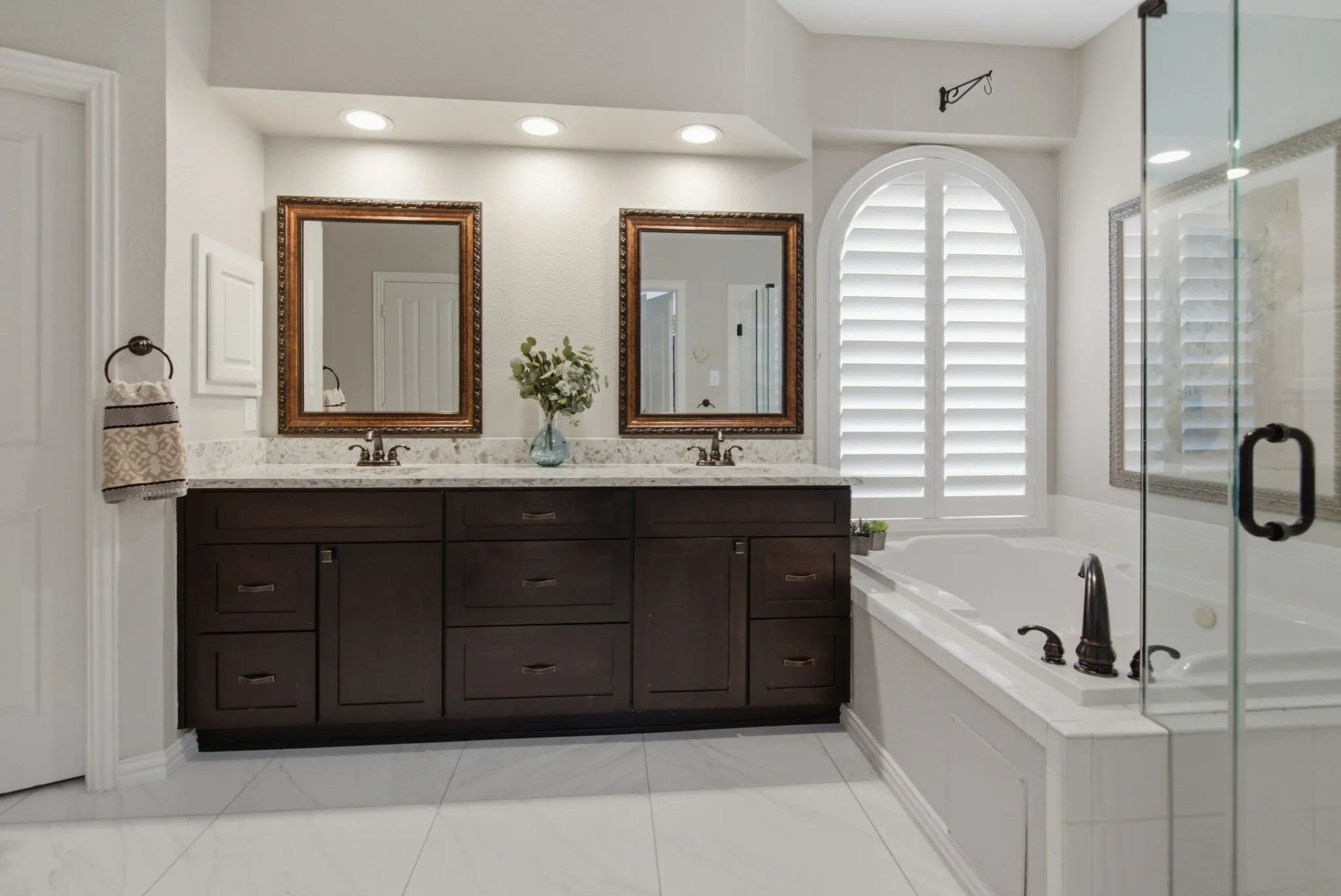 Updated vanity with two sinks, beautiful quartz countertop and medicine cabinet.