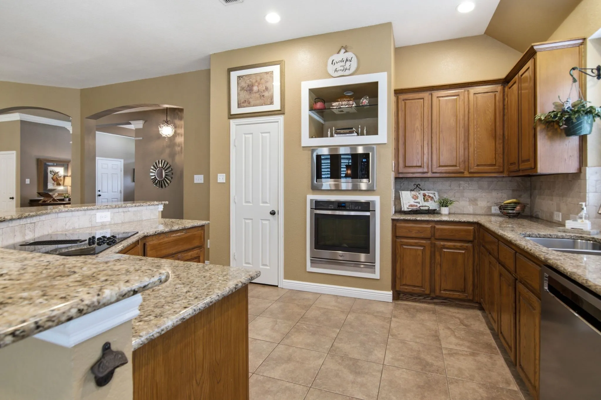 Entertain your family and friends in this nice size kitchen with stainless applicance, built in microwave, electric cooktop, breakfast bar, and pantry.