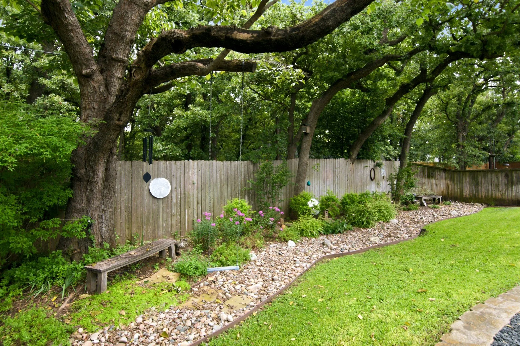 Along the back of the property you will find mature trees for additional privacy and shade.
