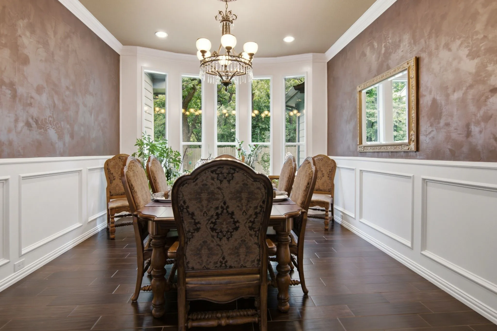 This room is currently being used as a formal dining area, but it has also been used as another living. This room features a bay window, crown molding and beautiful wainscoting.