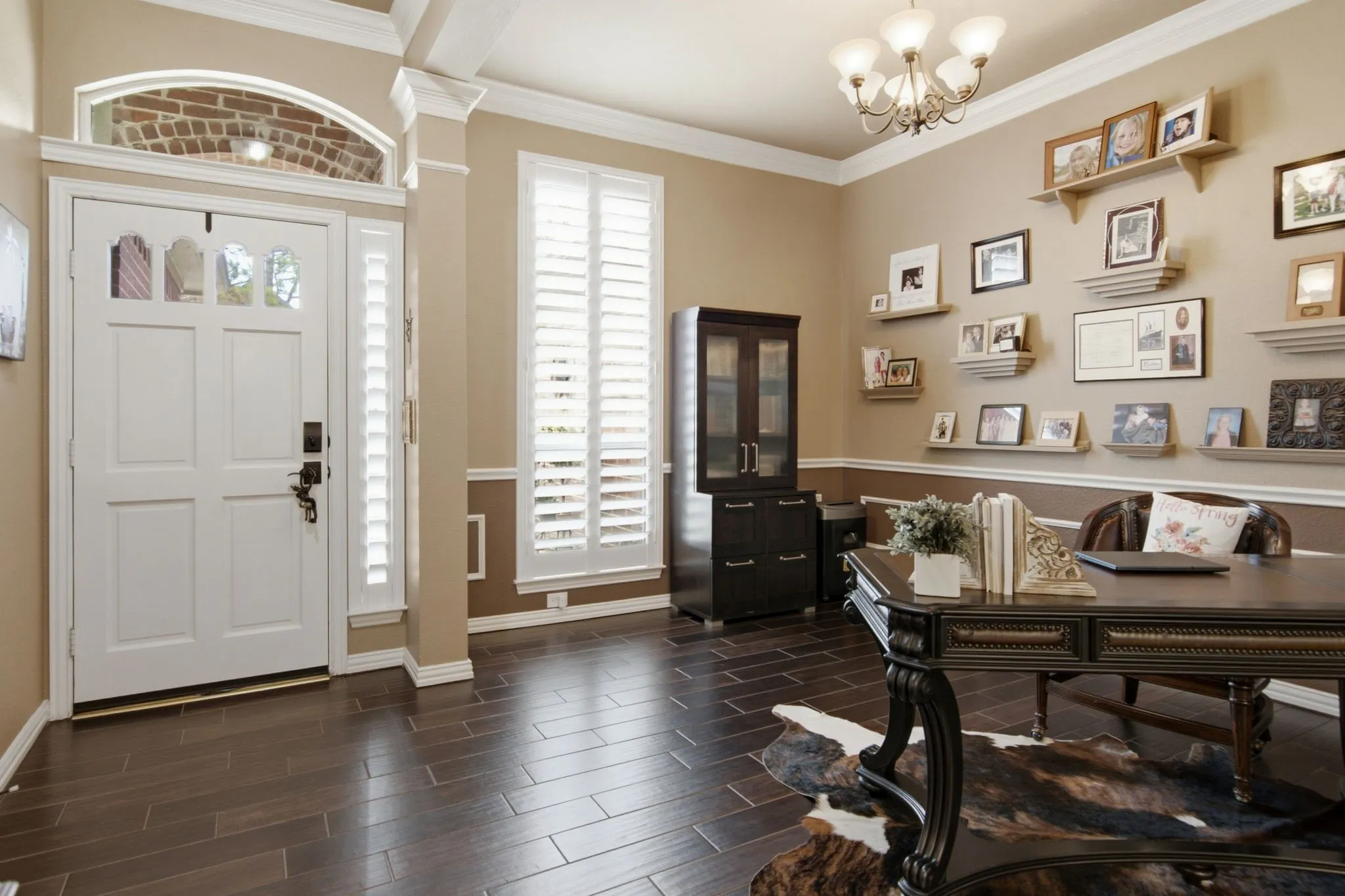 As you enter the home you will welcomed by beautiful wood like tile floors, plantation shutters and crown molding.