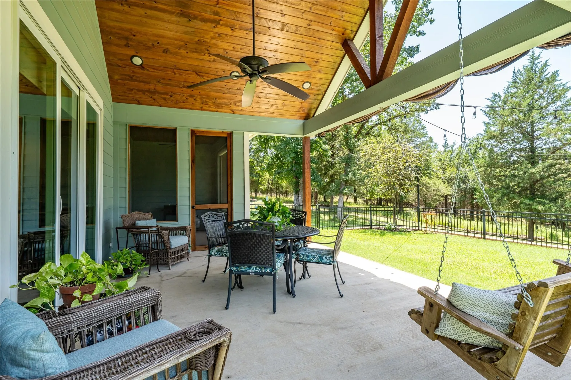 Covered back porch with veranda styled back yard overlooking the 5+ acres of property.  Very very private.