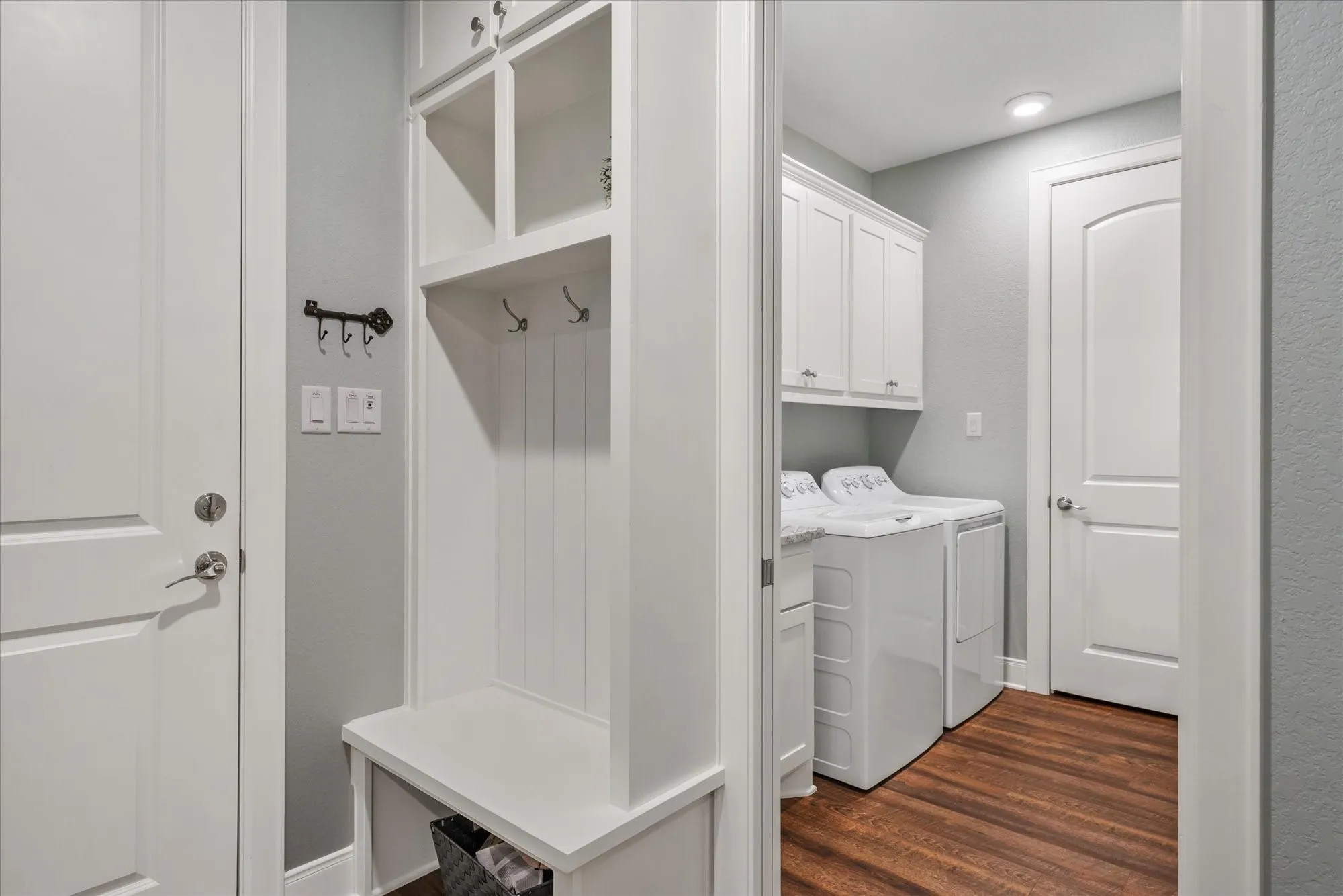 Mud room leading into dedicated laundry room and spacious utility closet.