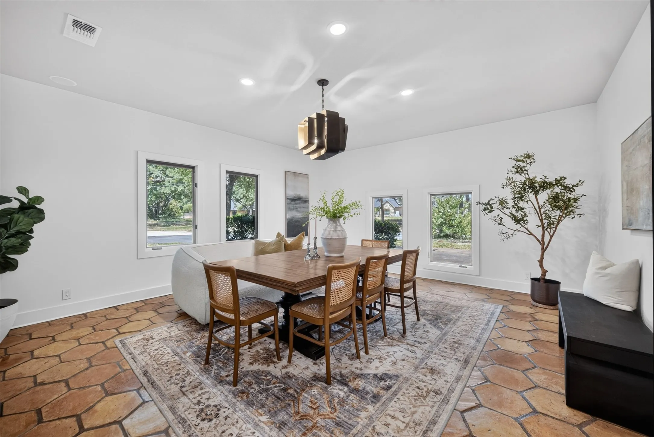Spacious interior featuring a distinctive polygonal tile floor and crisp white walls