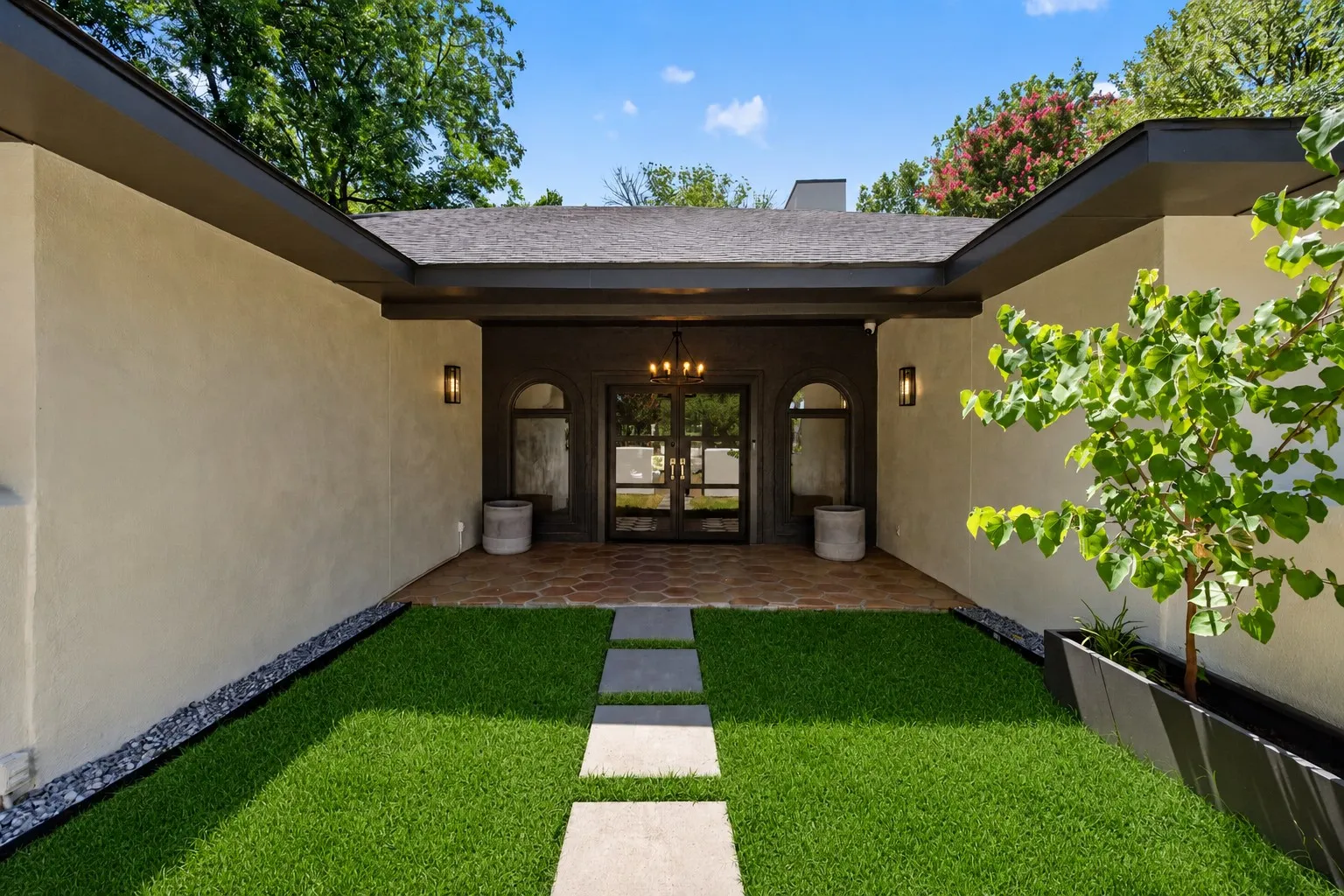 Contemporary stucco exterior with a dark trim roofline