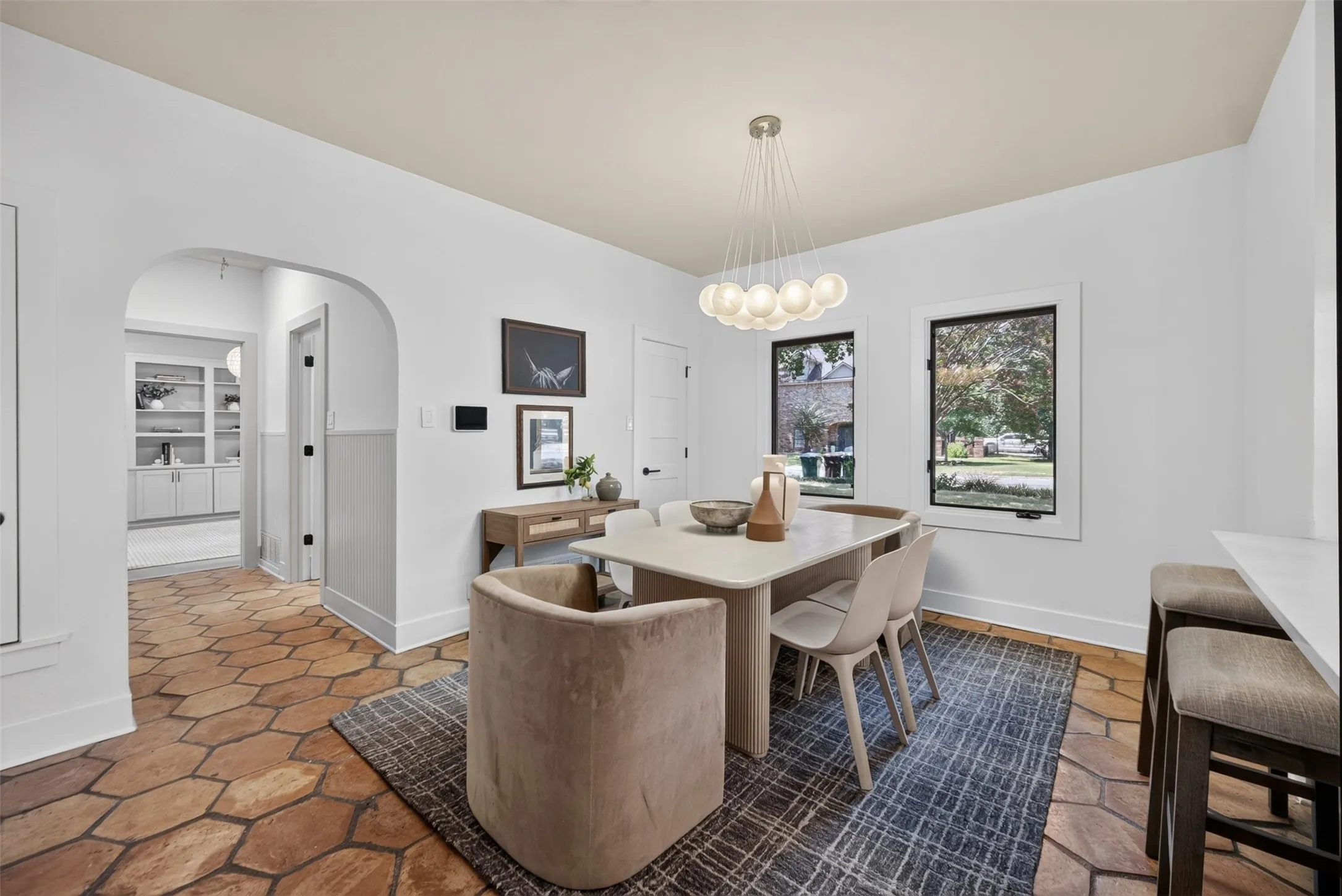 Dining area featuring a contemporary multi-globe pendant light fixture