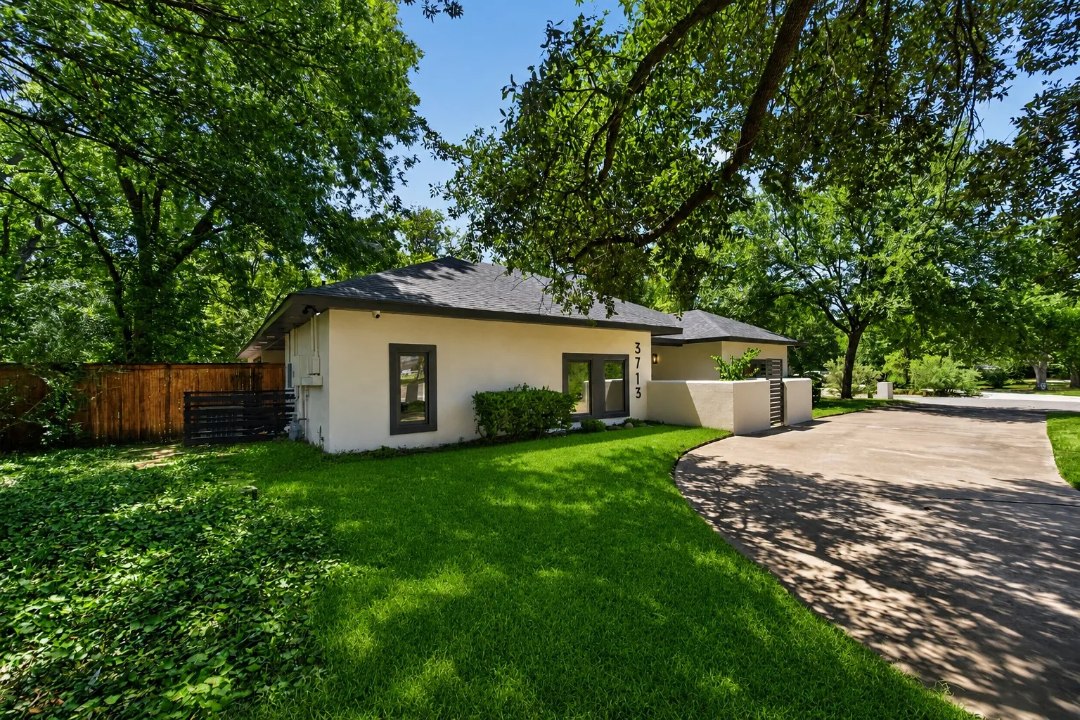 Contemporary stucco exterior with dark trim windows