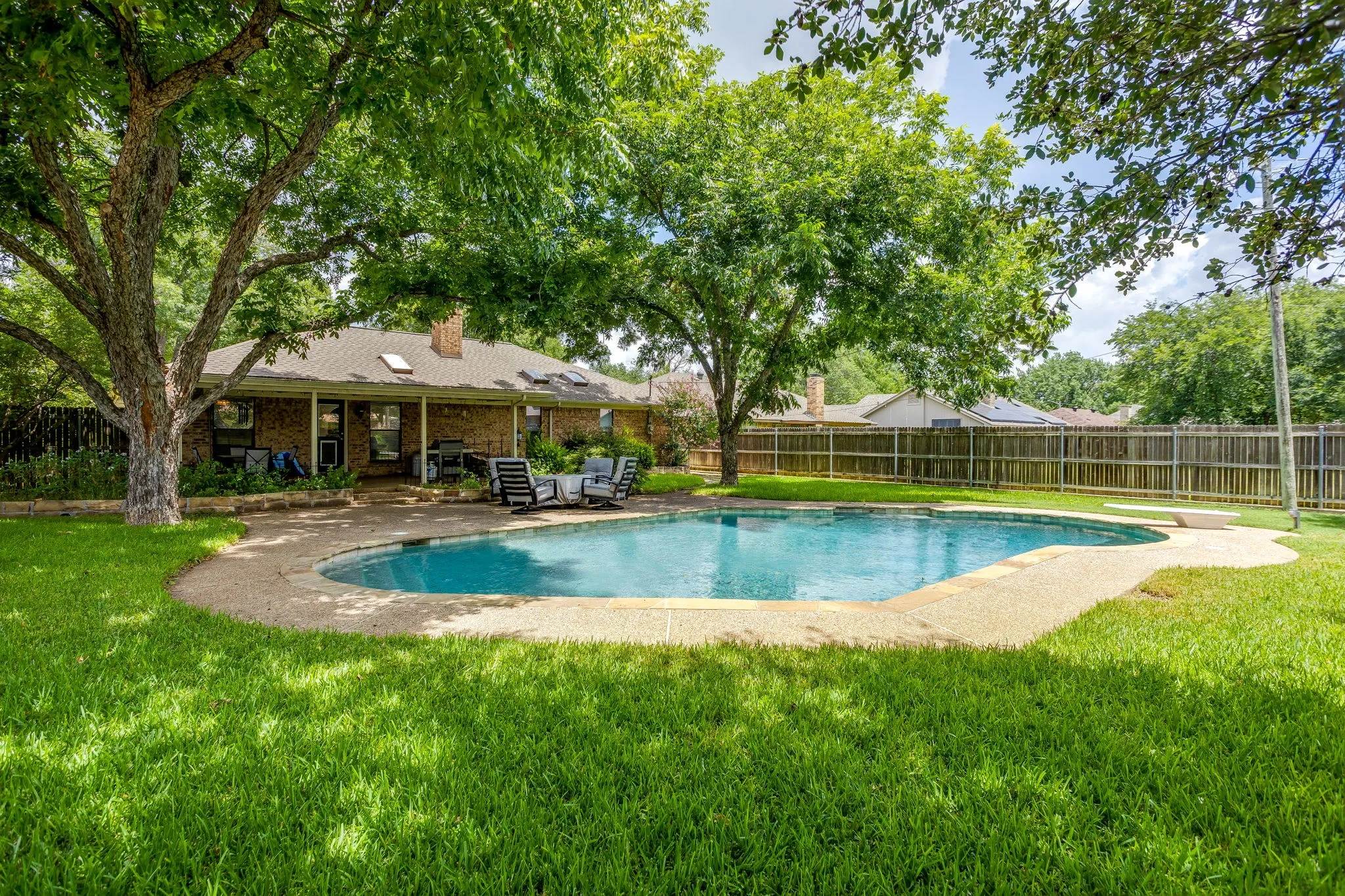 Lush landscaping surrounding the pool.