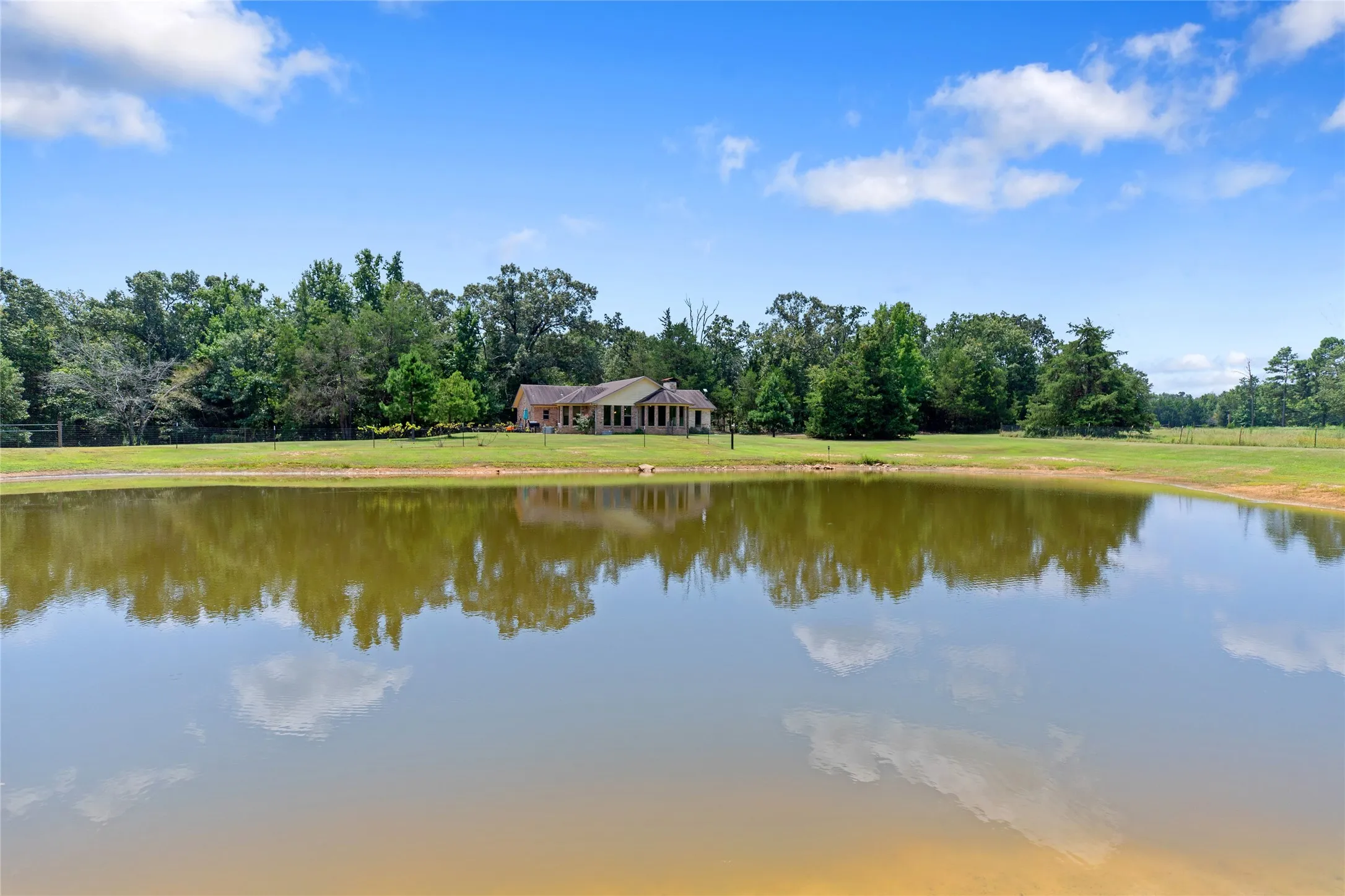 Close up water view of the pond showcasing the calm, serene country environment.
