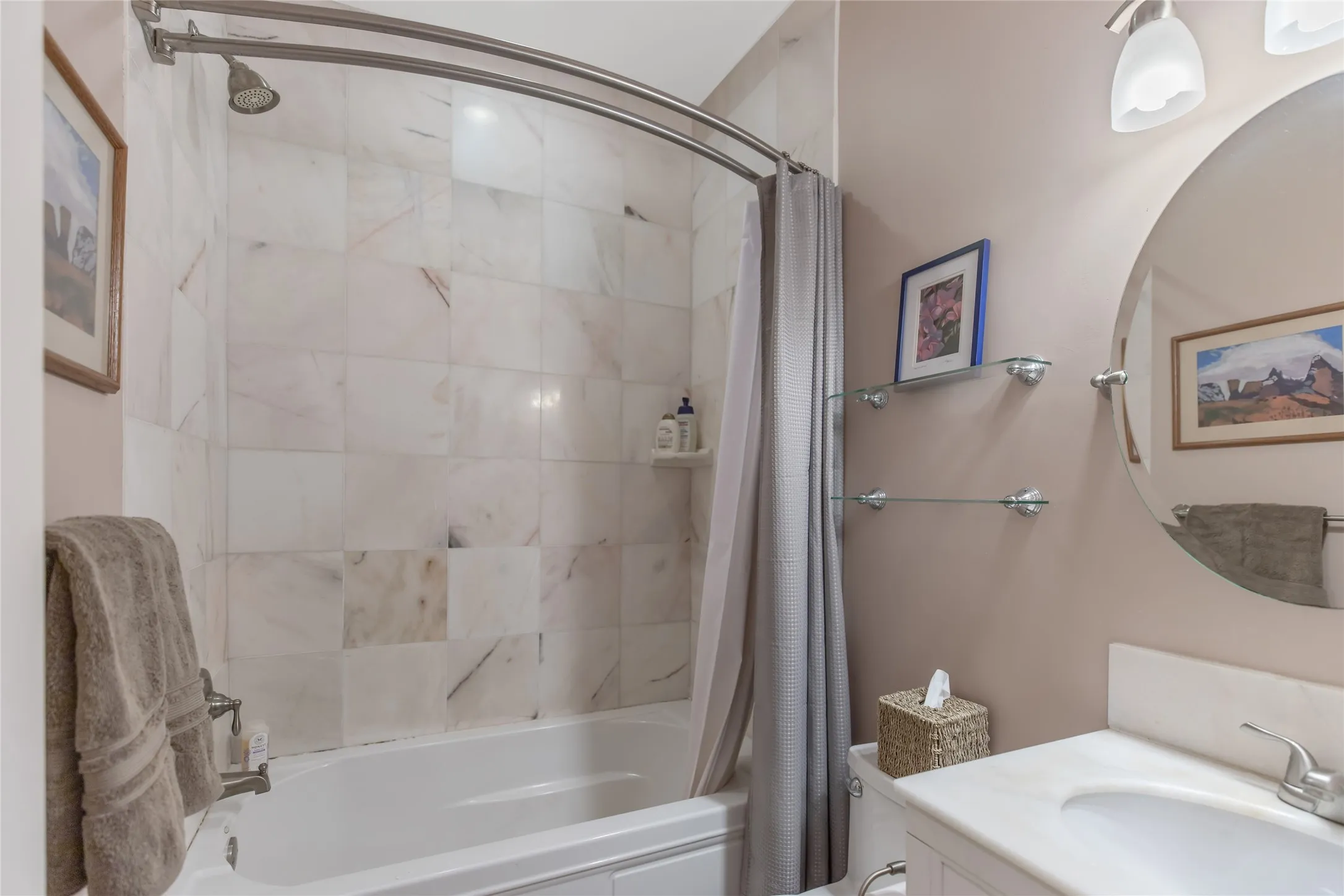 Second full bathroom featuring a tub and shower combo with custom tile work.