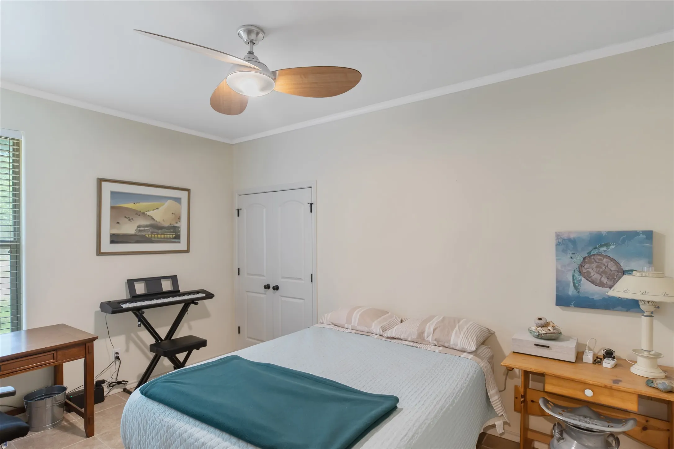 Third bedroom with neutral paint, a ceiling fan, and plenty of natural light for guests or a home office.