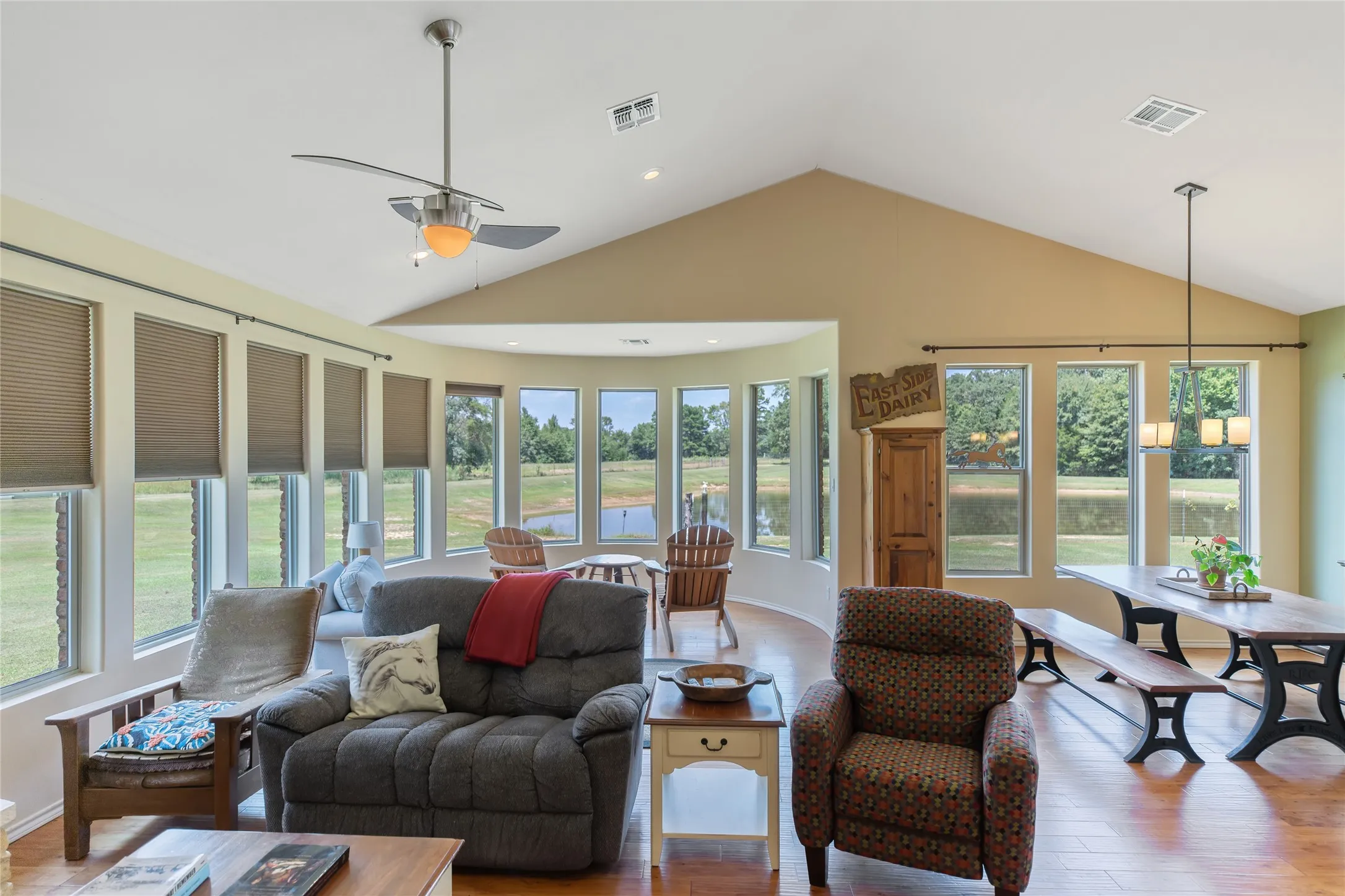 Spacious living room with a stone fireplace, nineteen new energy efficient windows, and ample natural light.