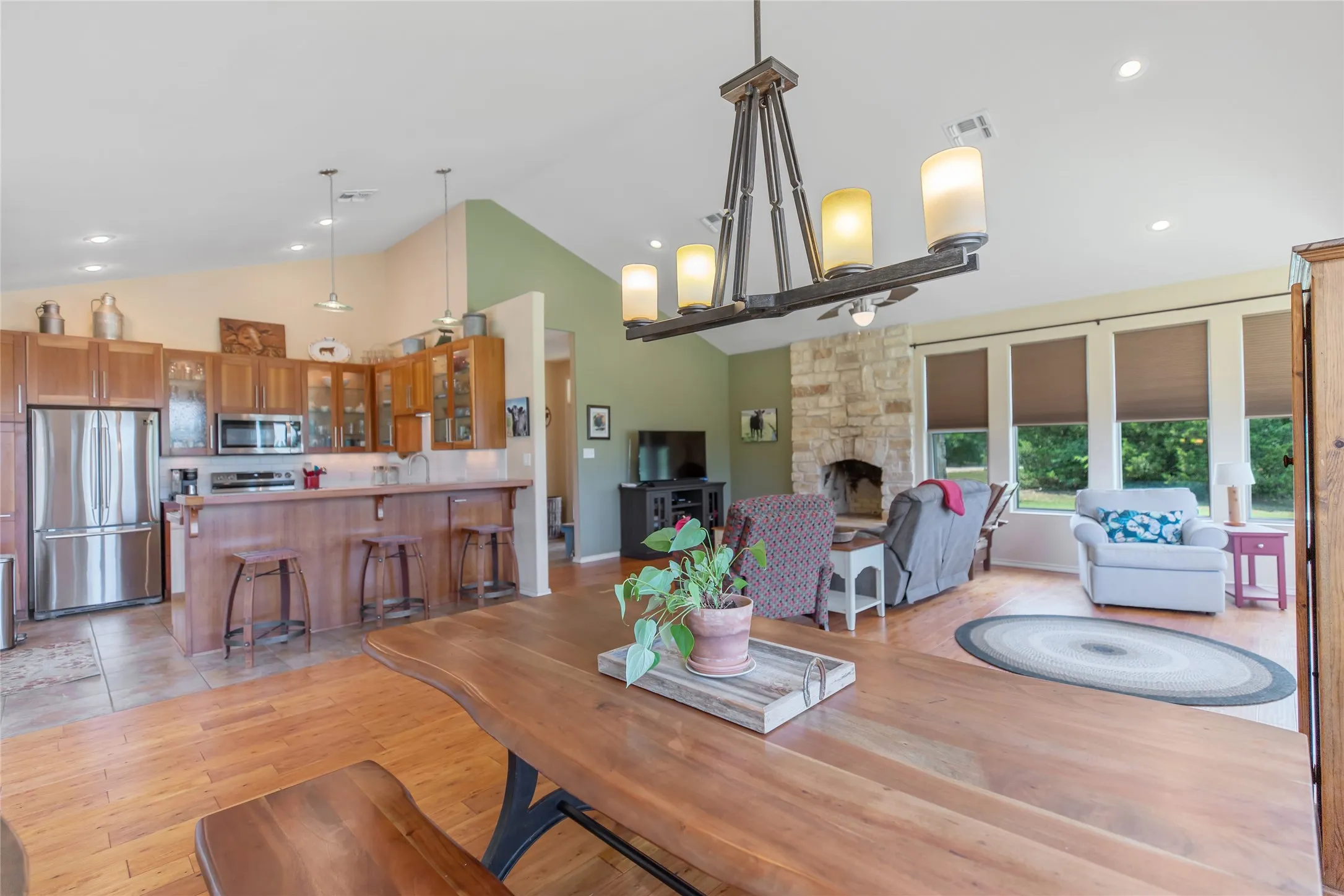 Open concept dining space with a view of the spacious living room and wood style flooring.