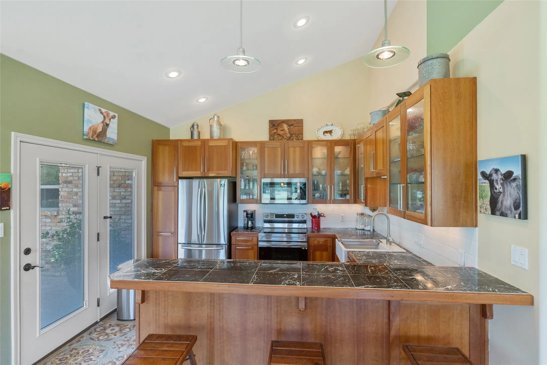 Gourmet kitchen featuring a spacious island, stainless steel appliances, and custom wood cabinetry.