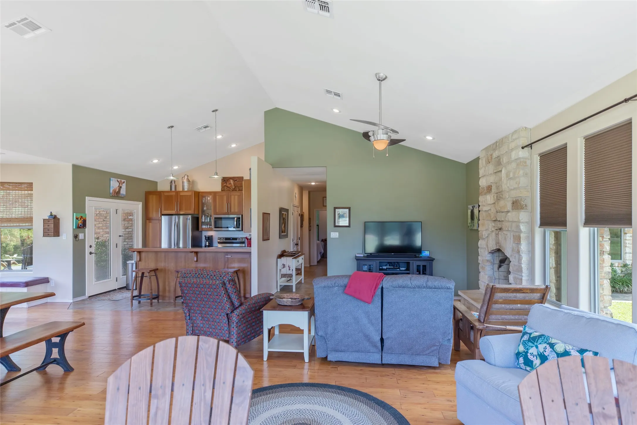 Open floor plan view from the living room showcasing the bright airy layout and backyard views.