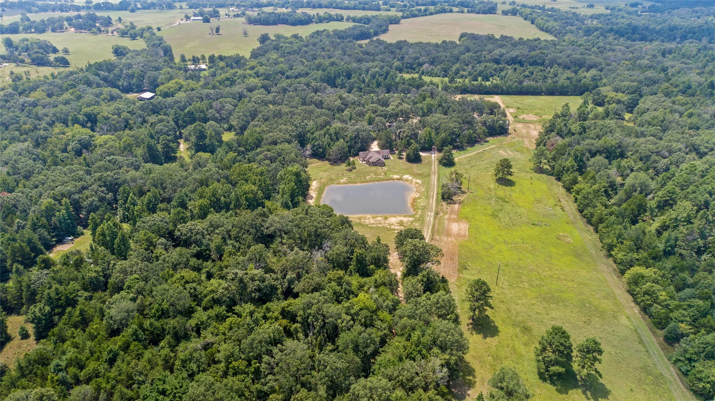 Distant aerial shot displaying the cross fenced pastures and expansive land boundaries.
