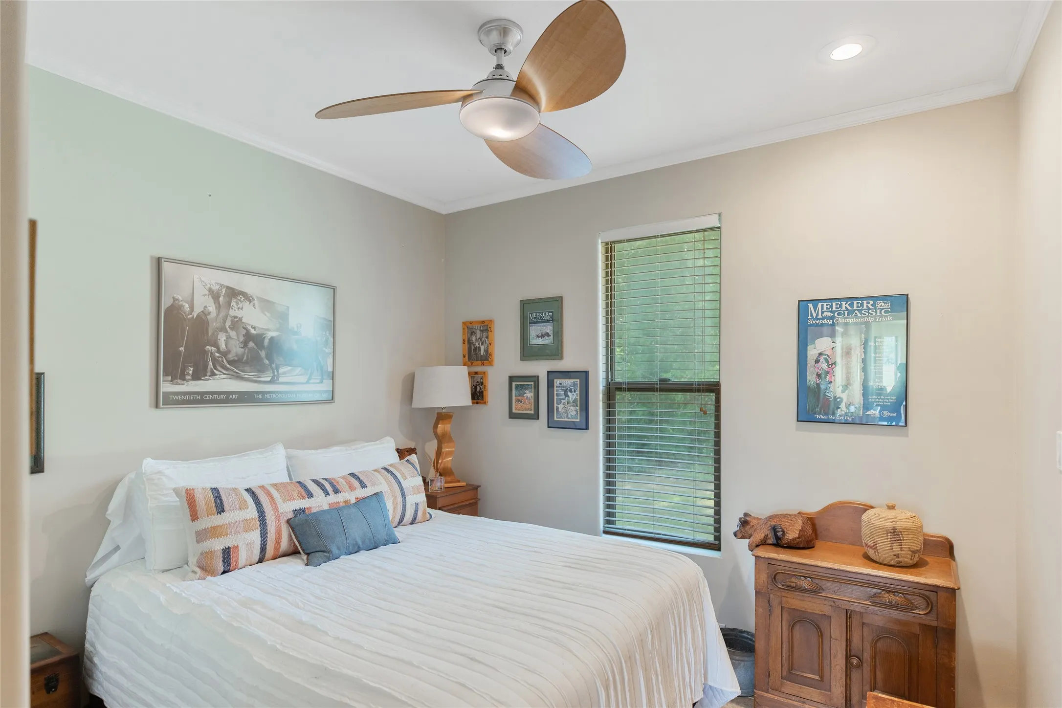 Second spacious guest bedroom featuring crown molding and views of the scenic East Texas property.