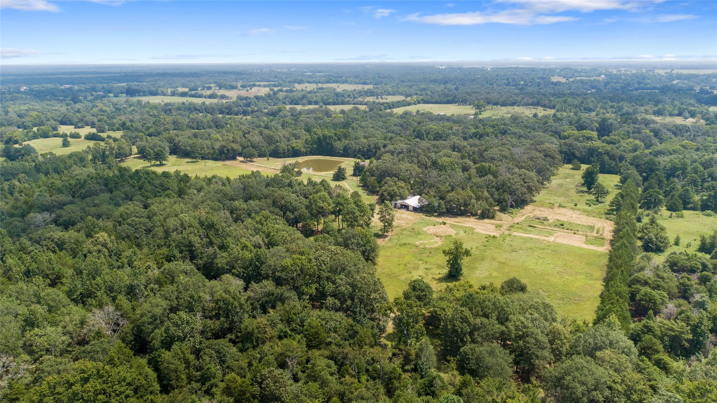 Expansive drone overview of the beautiful East Texas landscape and wooded property borders.