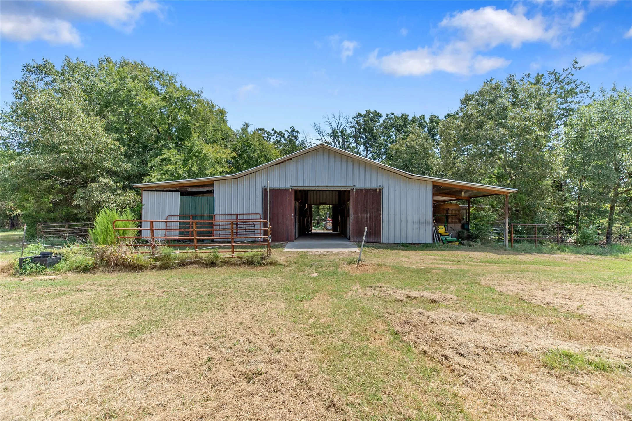 Exterior view of the professional horse barn and outbuildings on the East Texas property.