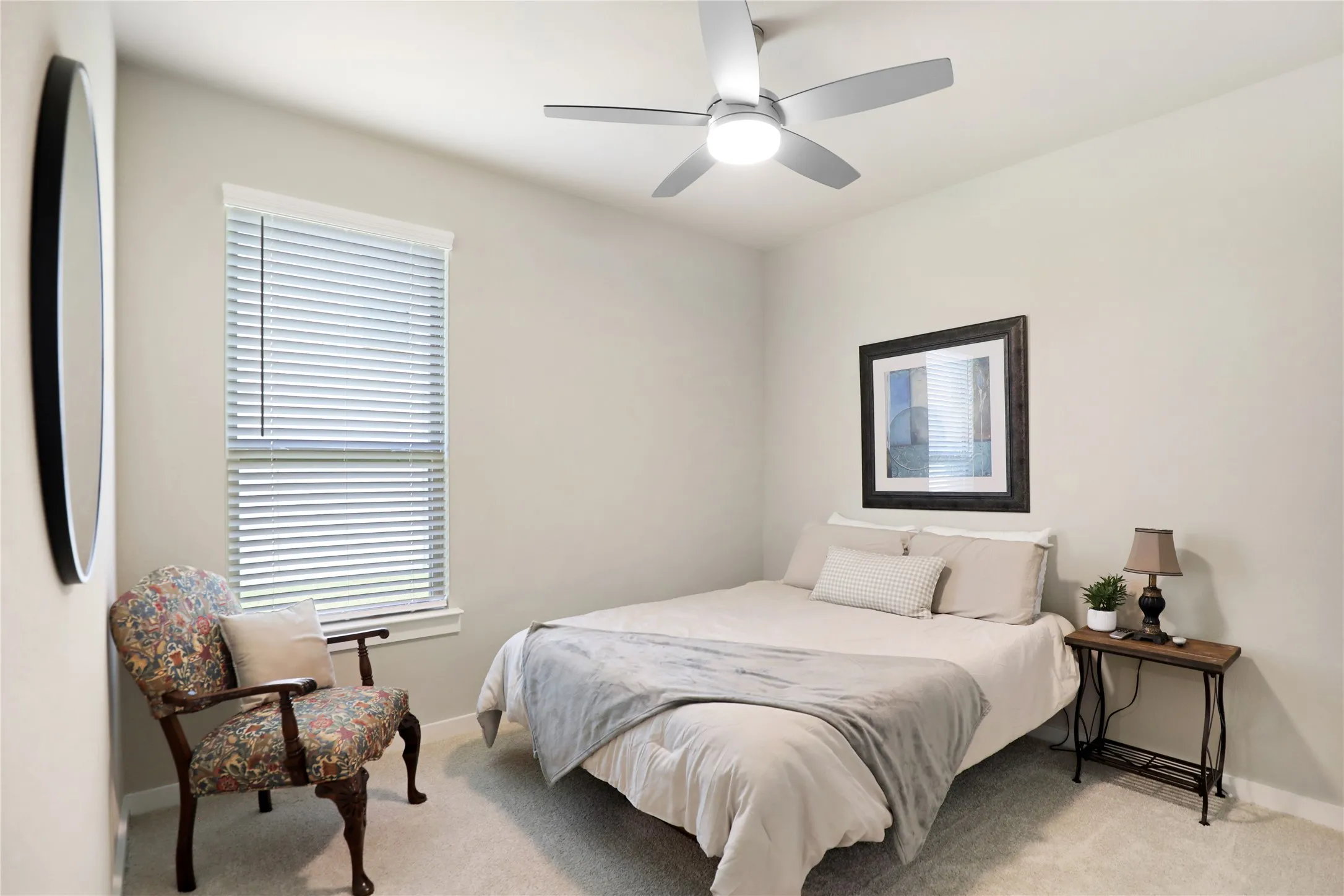 Room featuring a modern ceiling fan with integrated lighting, a window with horizontal blinds, and neutral-toned wall paint