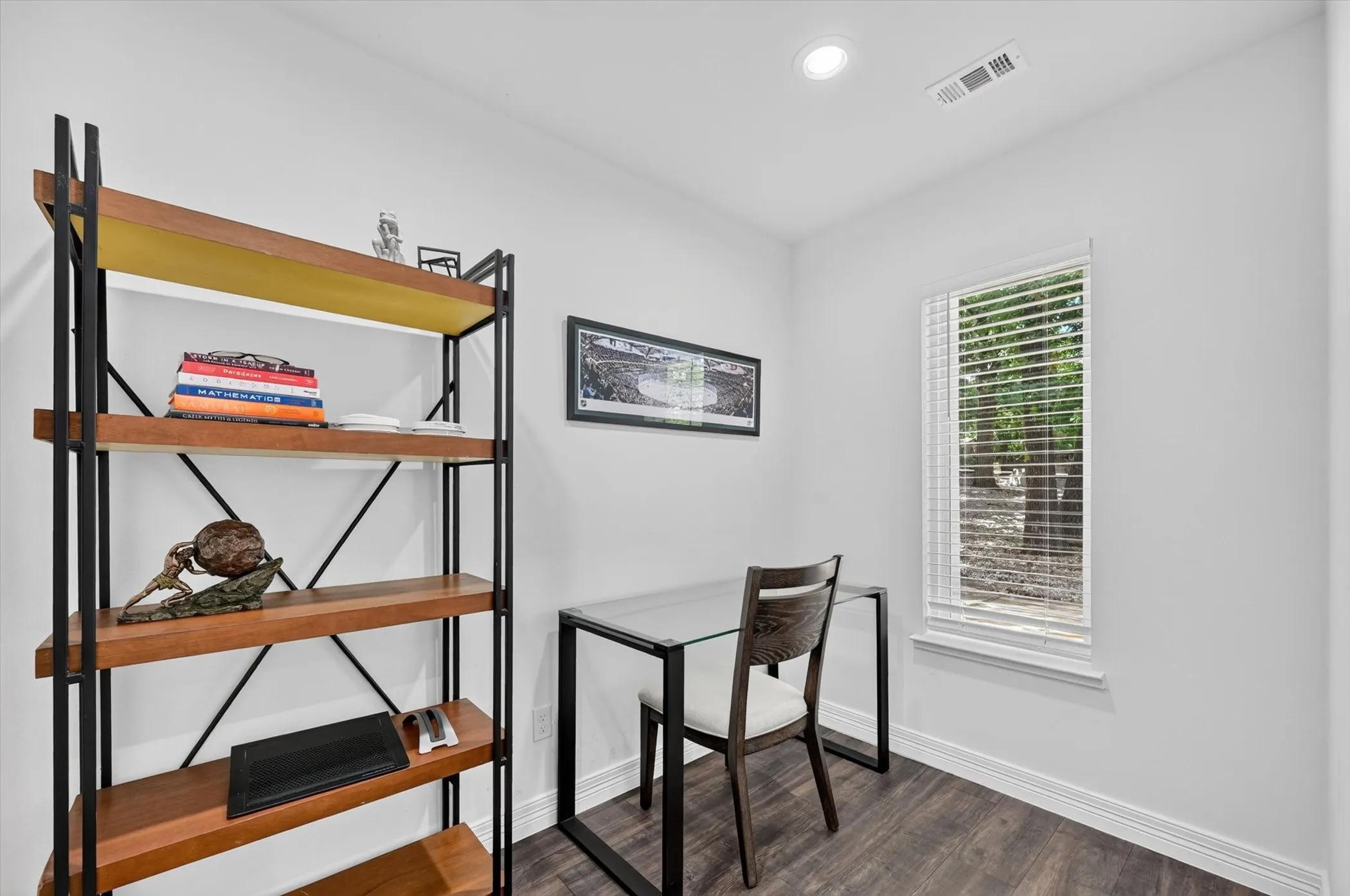 Bright room with a single window featuring horizontal blinds