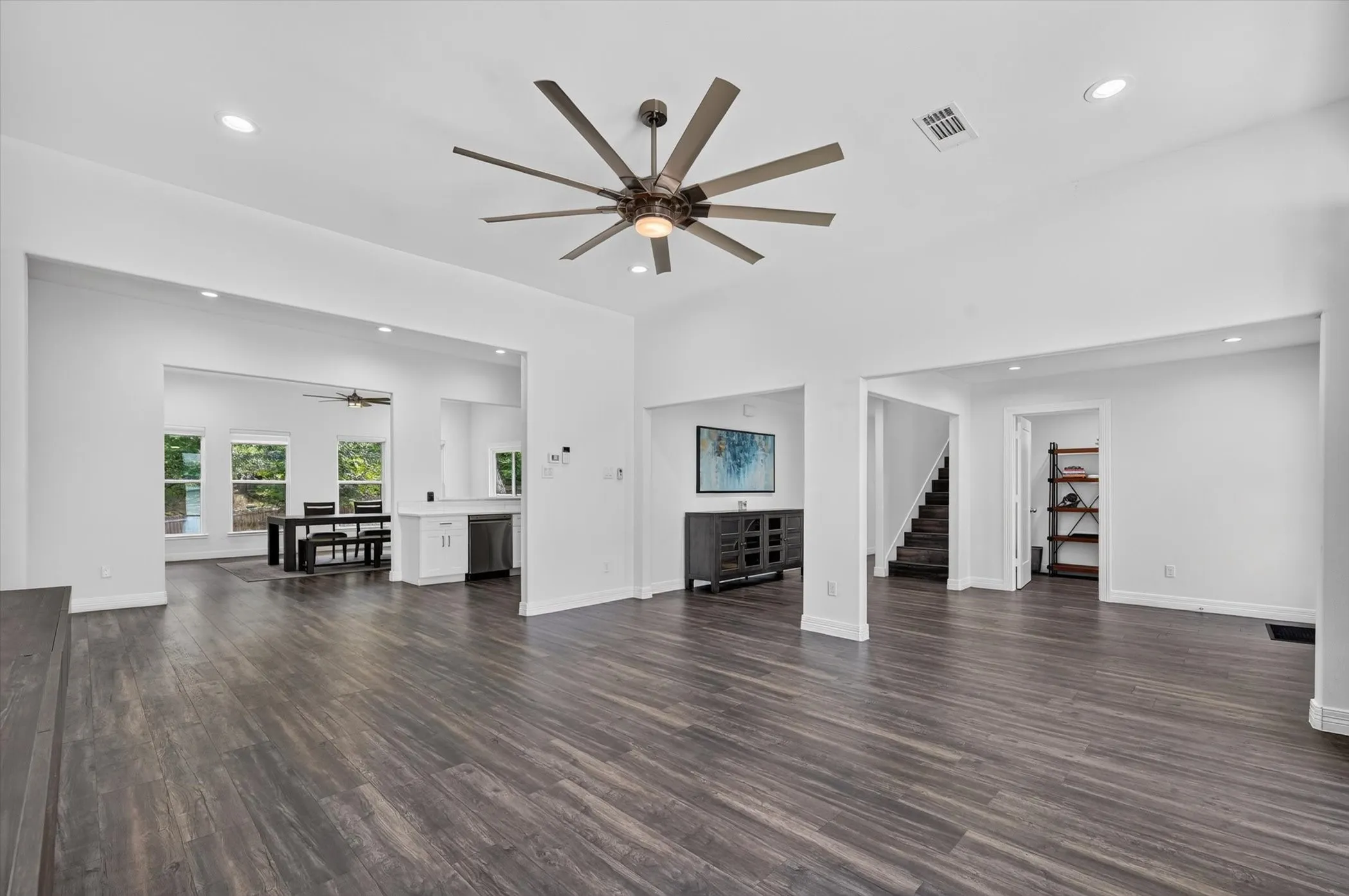 Spacious interior featuring wood-finish flooring, recessed lighting, and a contemporary ceiling fan