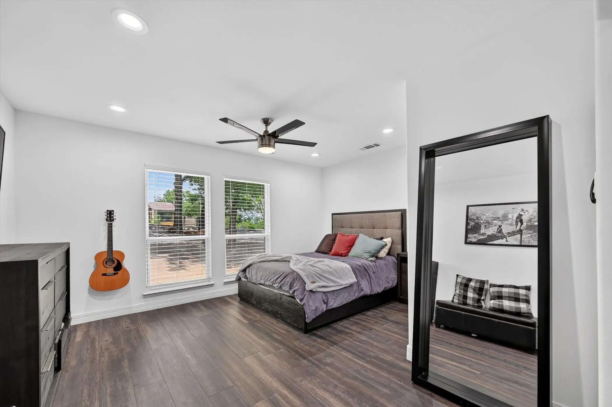 Bright room featuring wood-finish flooring and two large windows
