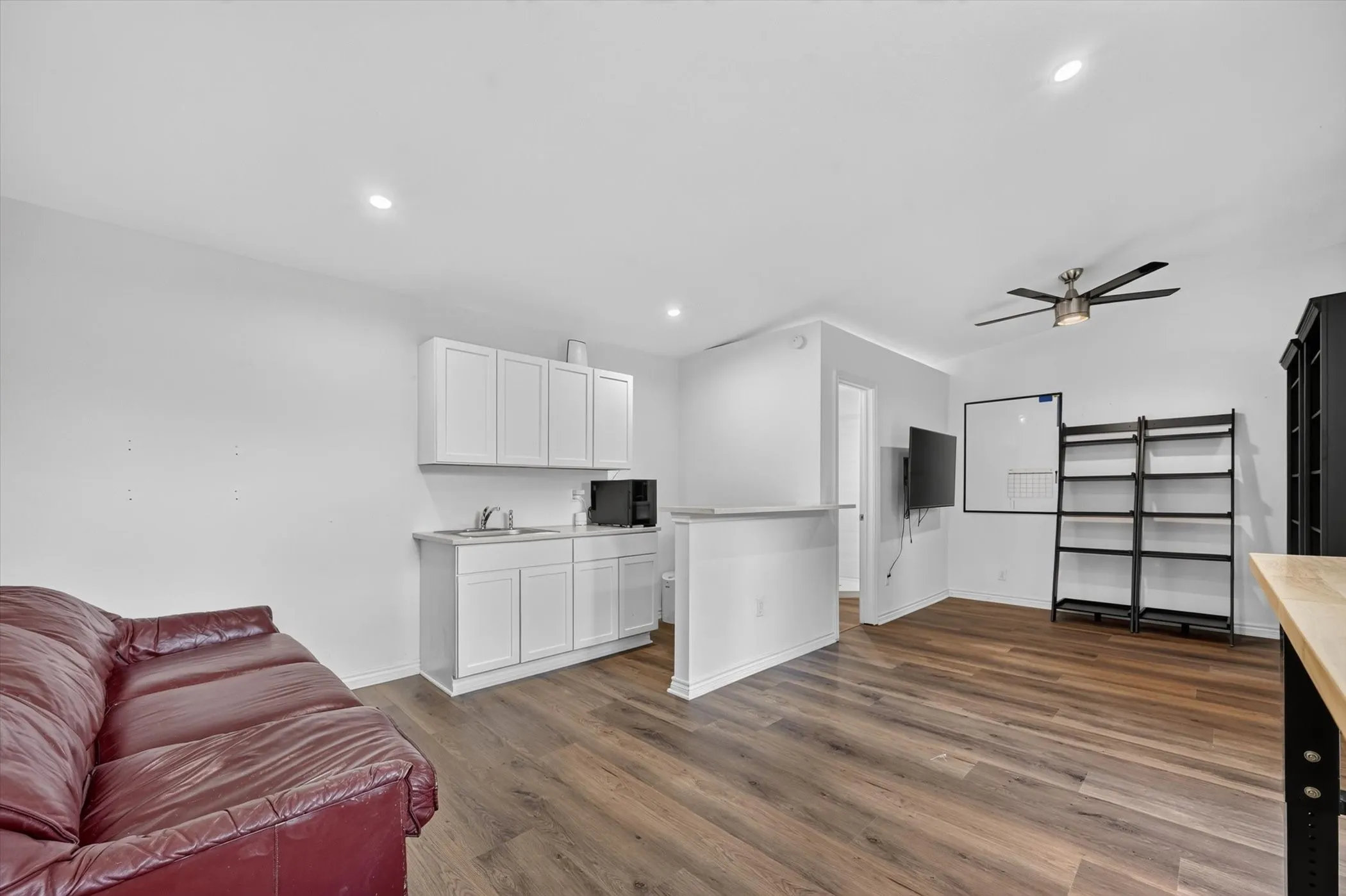 Open-concept living space featuring wood-finish flooring throughout