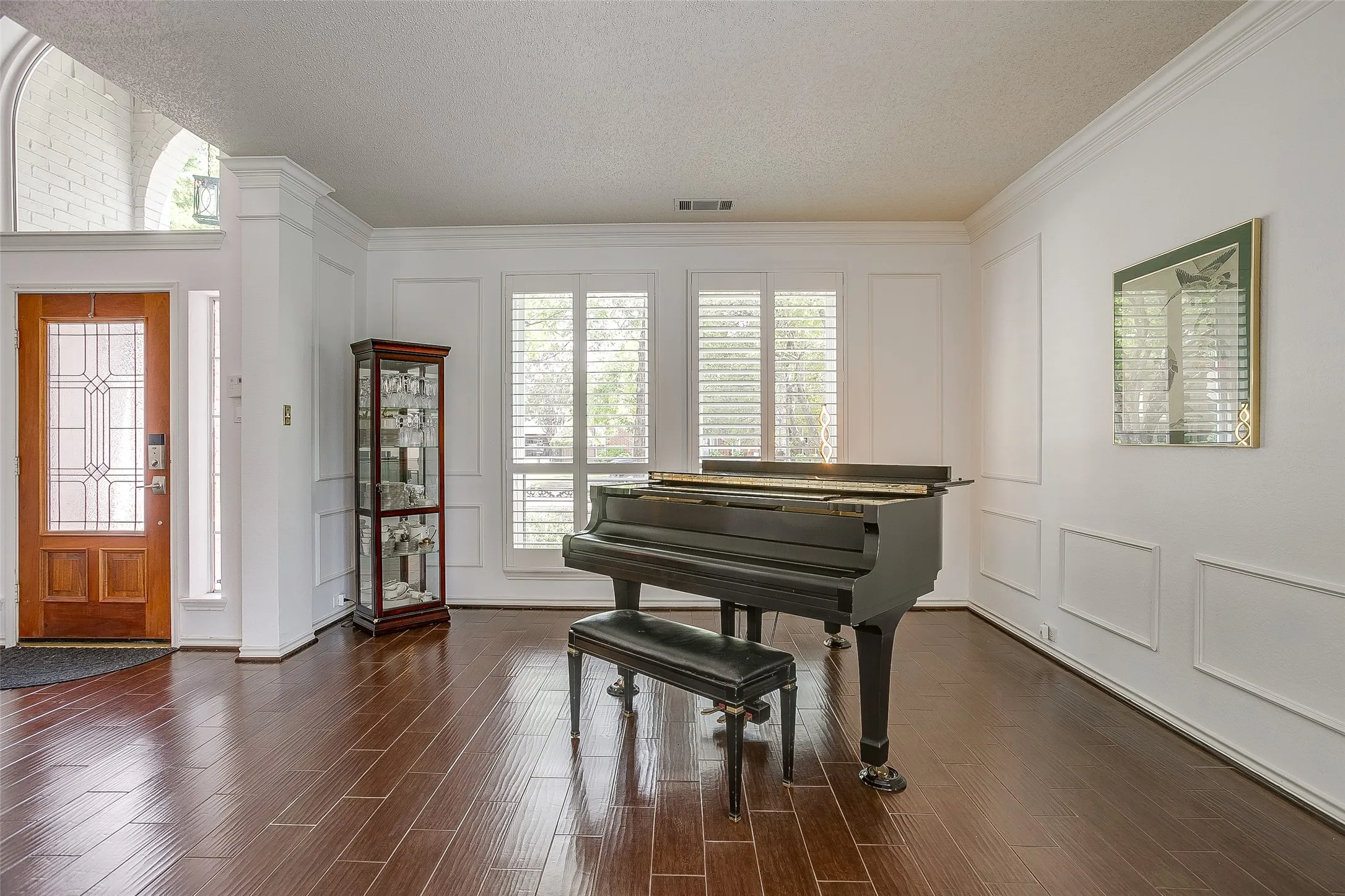 Custom shutters and beautiful wainscoting in the living area one.