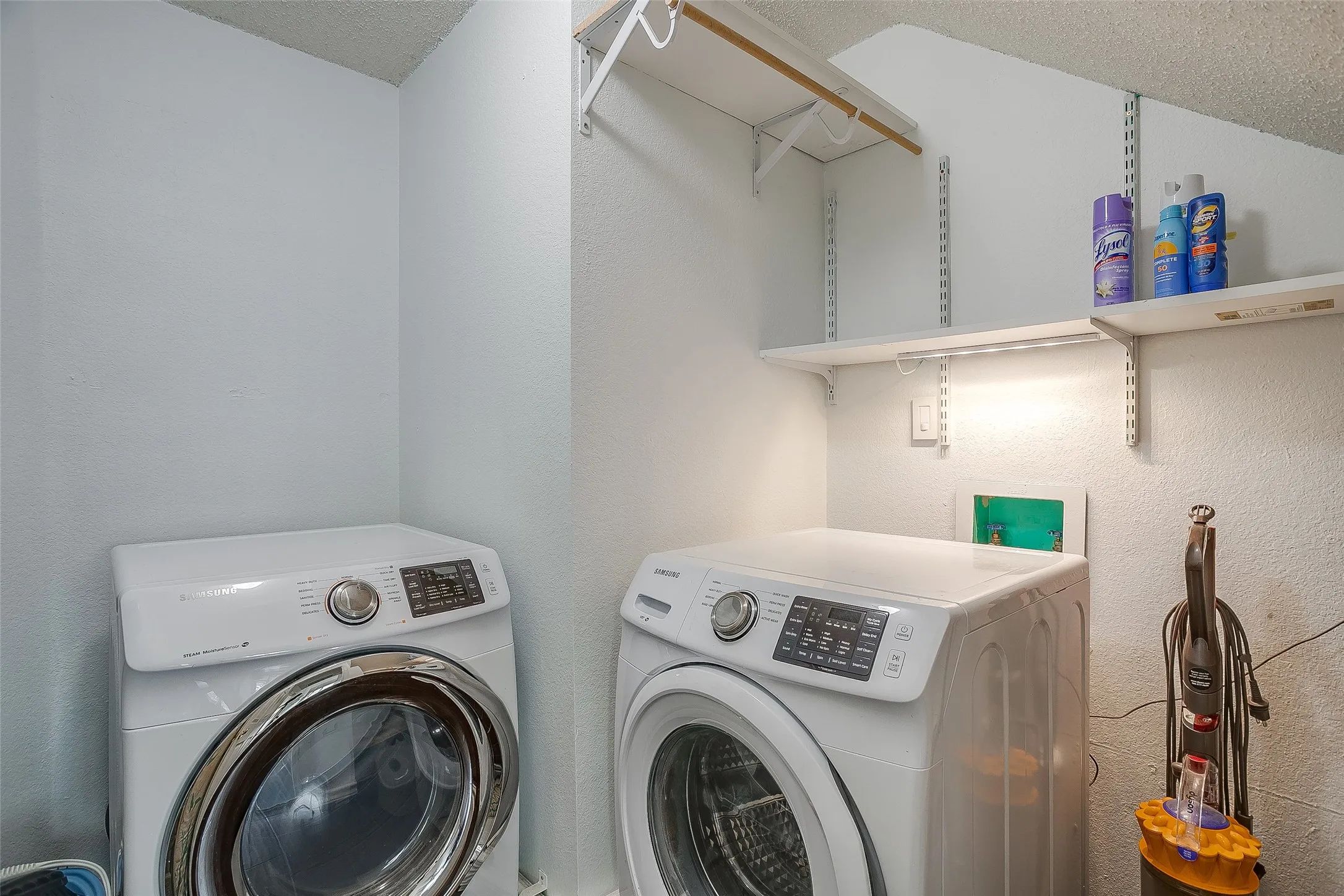 Built in shelving and handing rack in the utility room.