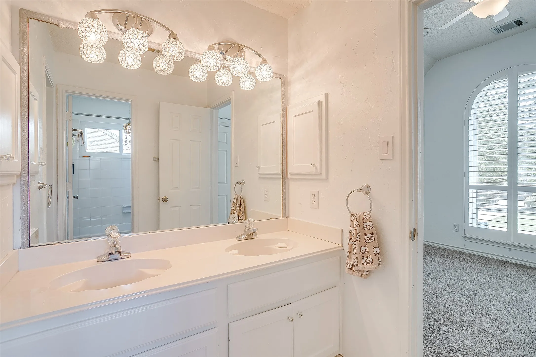 Second full bathroom upstairs with dual sinks.