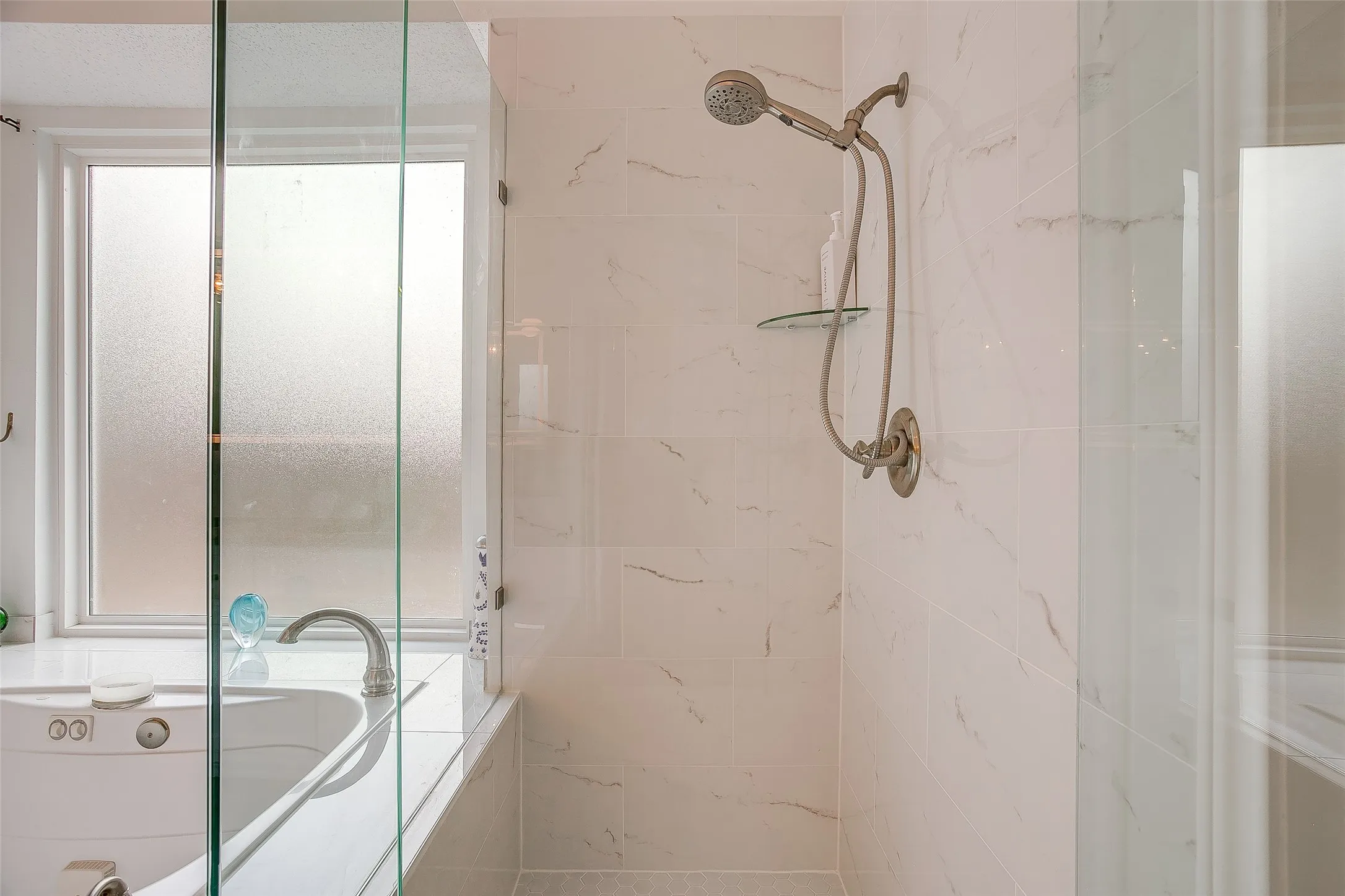 Newly remodeled glass enclosed shower.