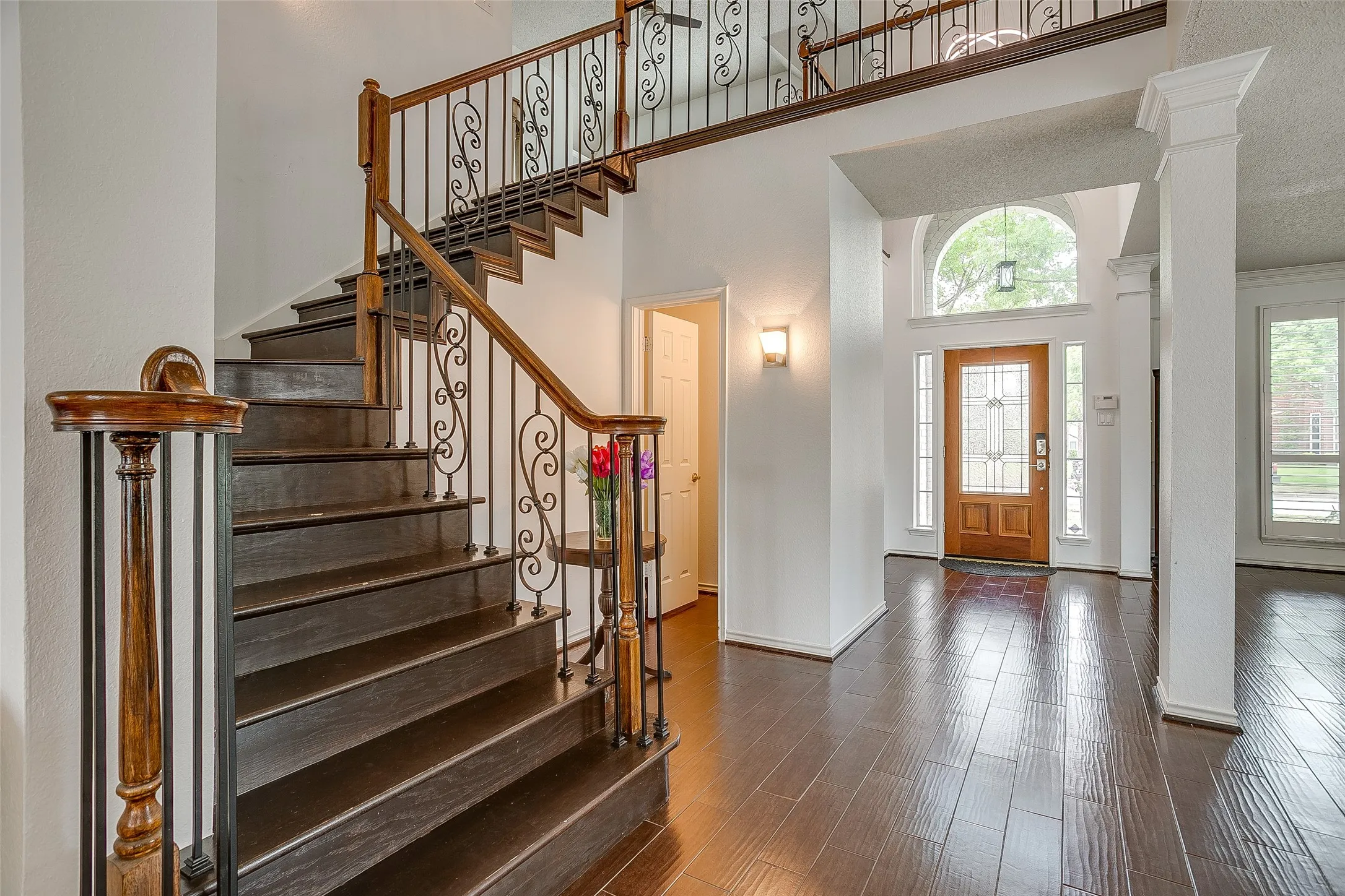 Classic wooden staircase with rich wrought-iron accents.