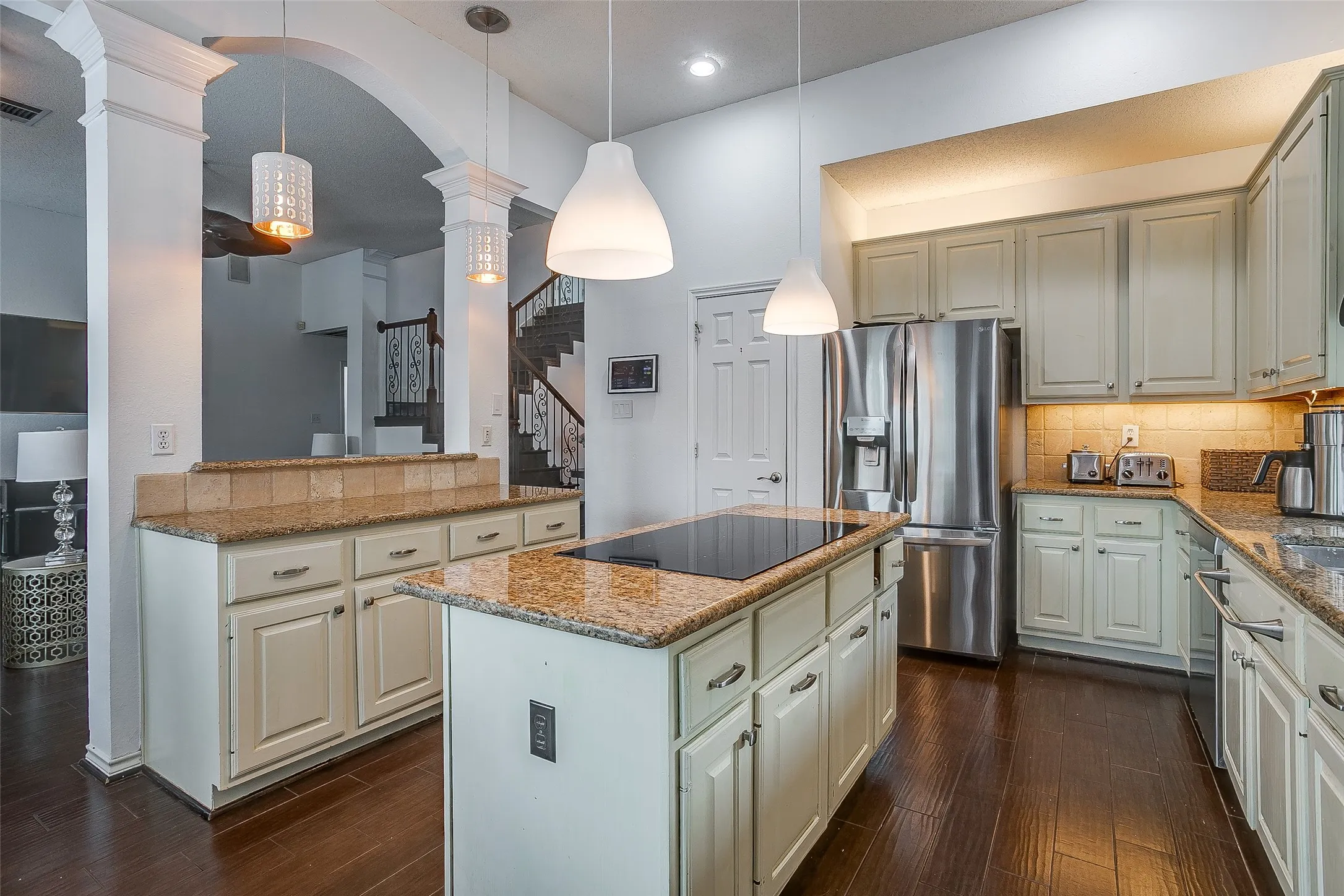 Granite countertops, kitchen island and plenty of cabinet space.