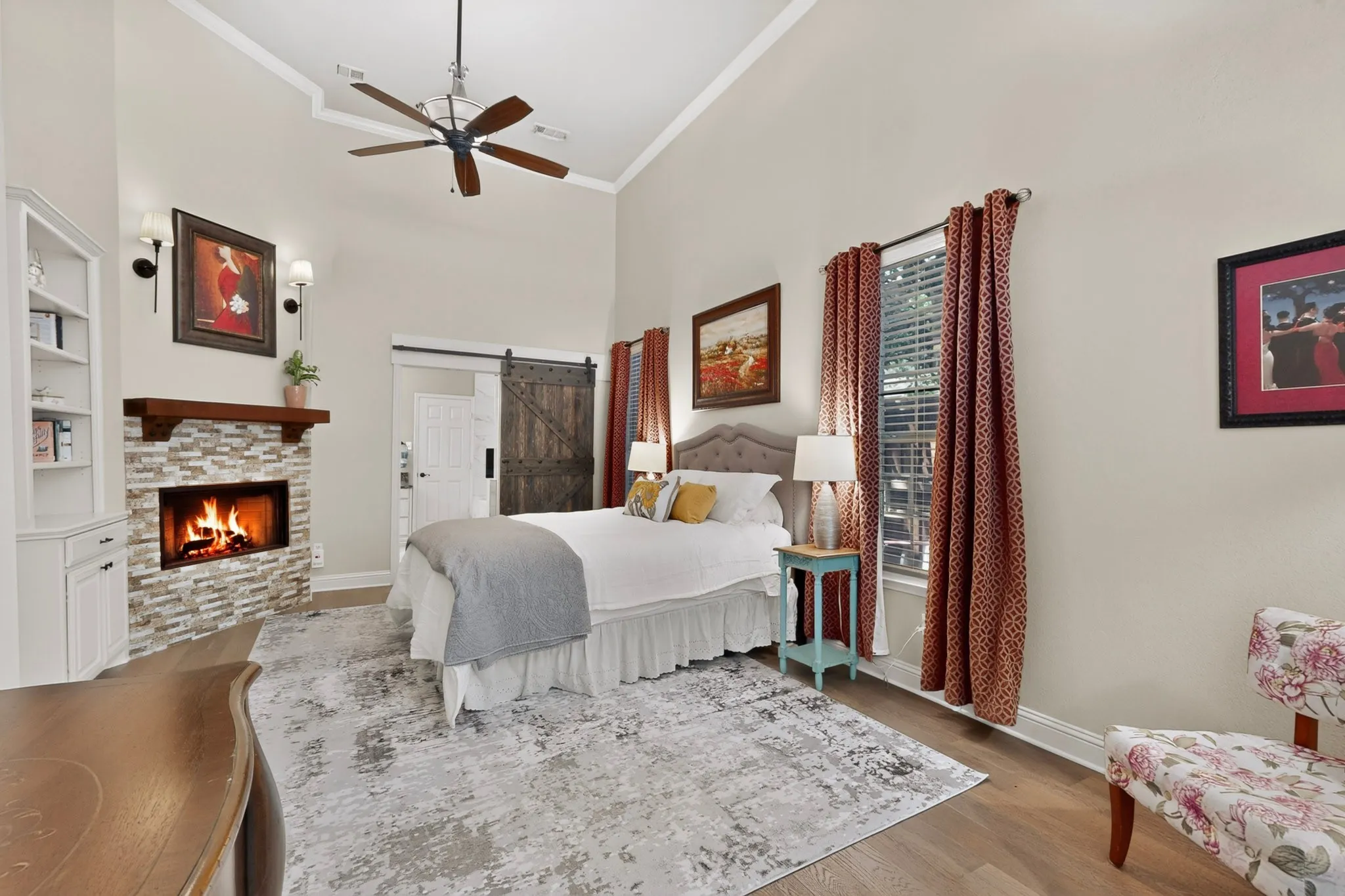 PRIMARY BEDROOM WITH GAS FIREPLACE AND CUSTOM BUILT IN BOOKCASE