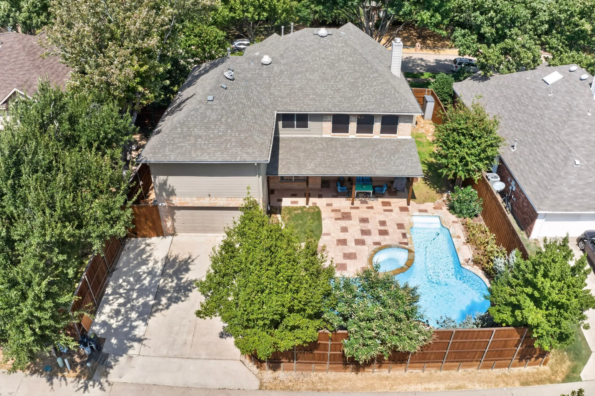 SPACIOUS POOL AND DECK AREA WITH 8 FOOT CEDAR BOARD ON BOARD FENCE FOR PRIVACY