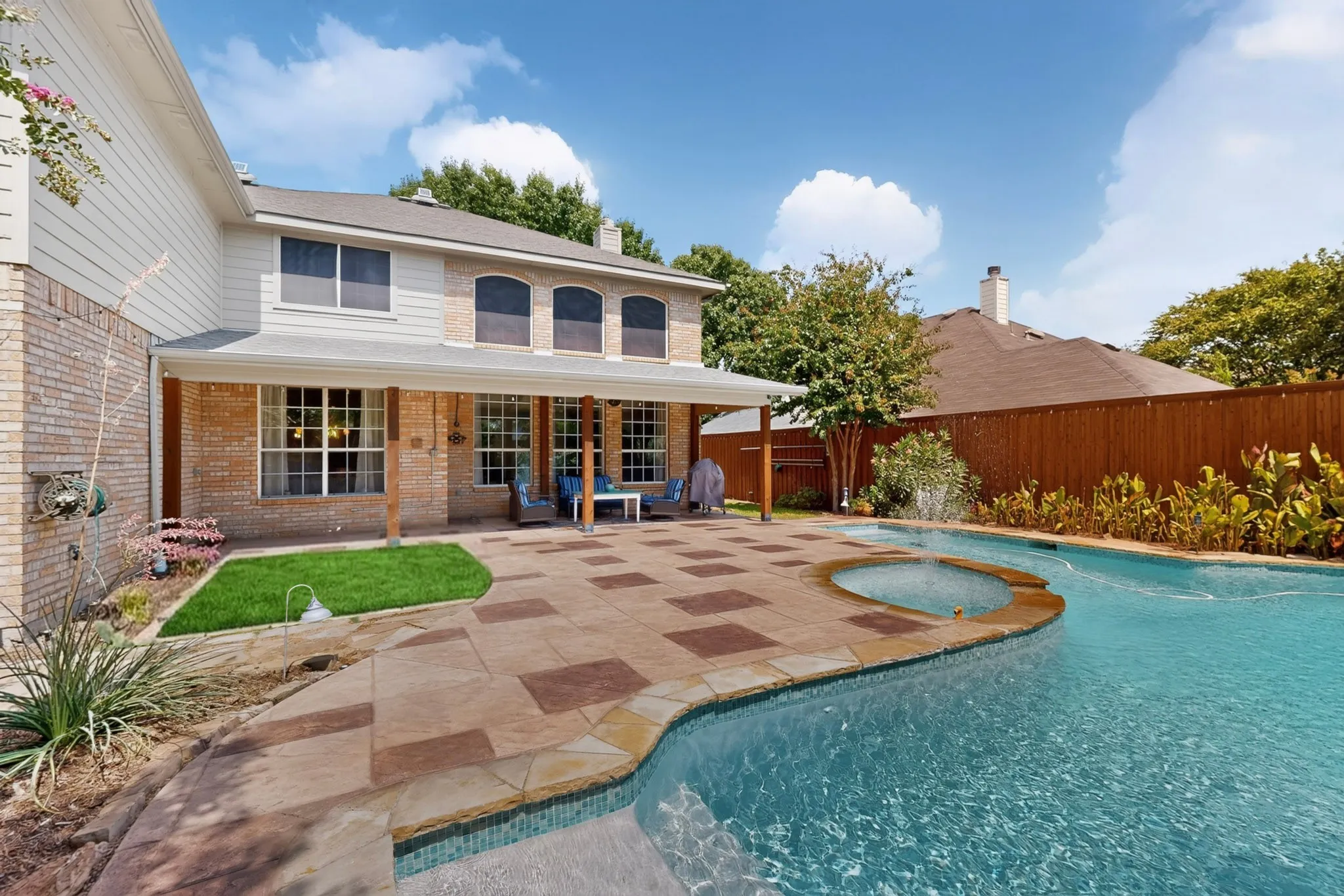 LARGE POOL AND SPA WITH STAMPED CONCRETE DECK