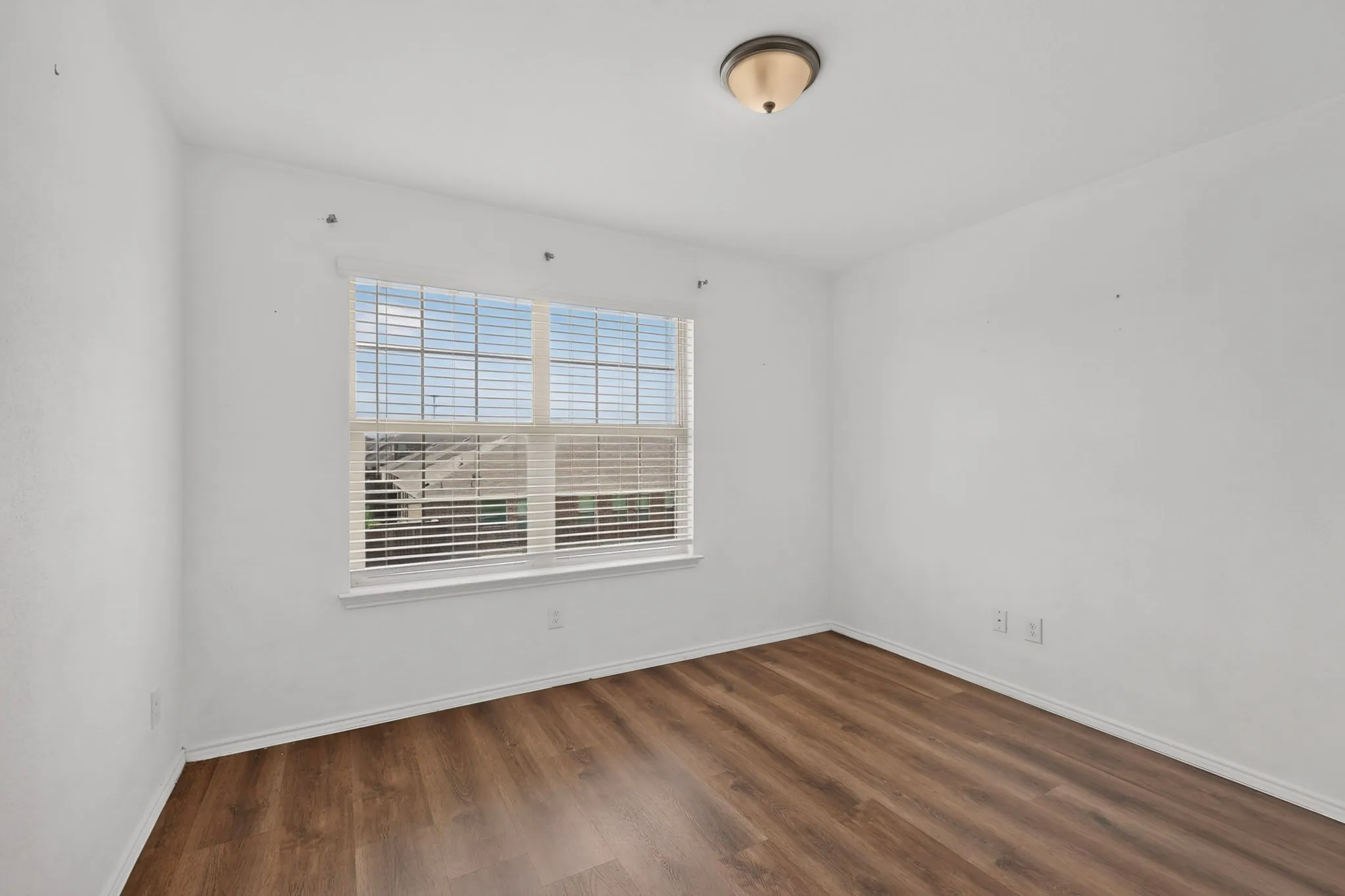 Bright interior room with wood-finish flooring