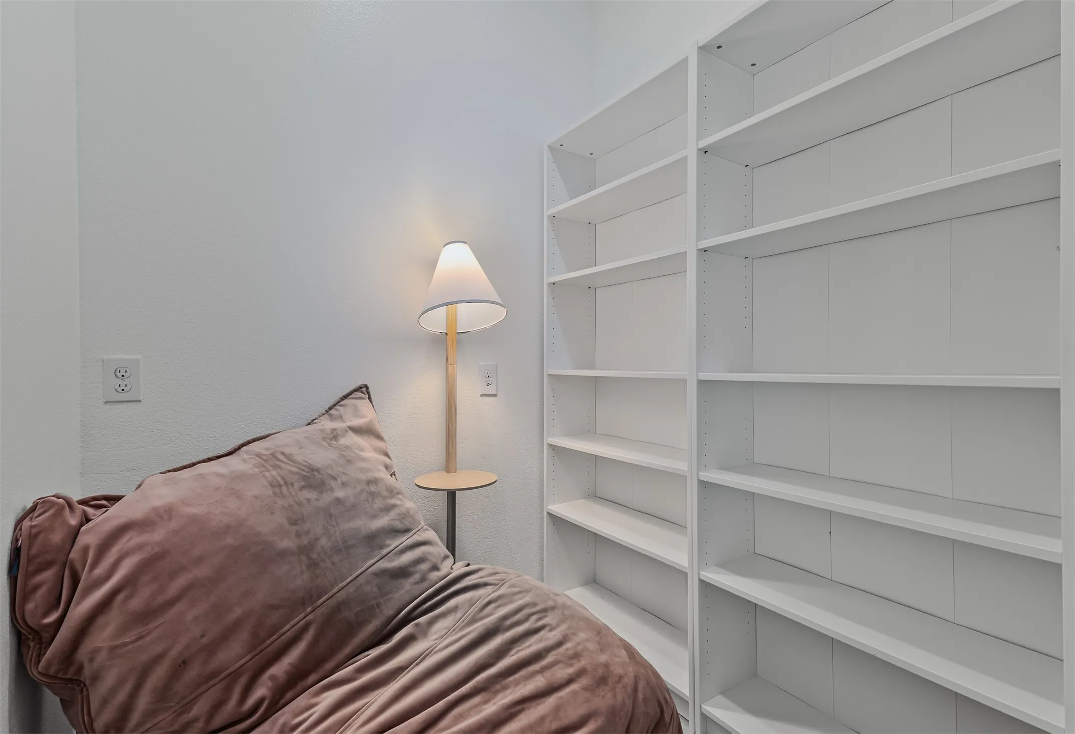 Cute little reading room with built in shelves in hallway by secondary bedrooms