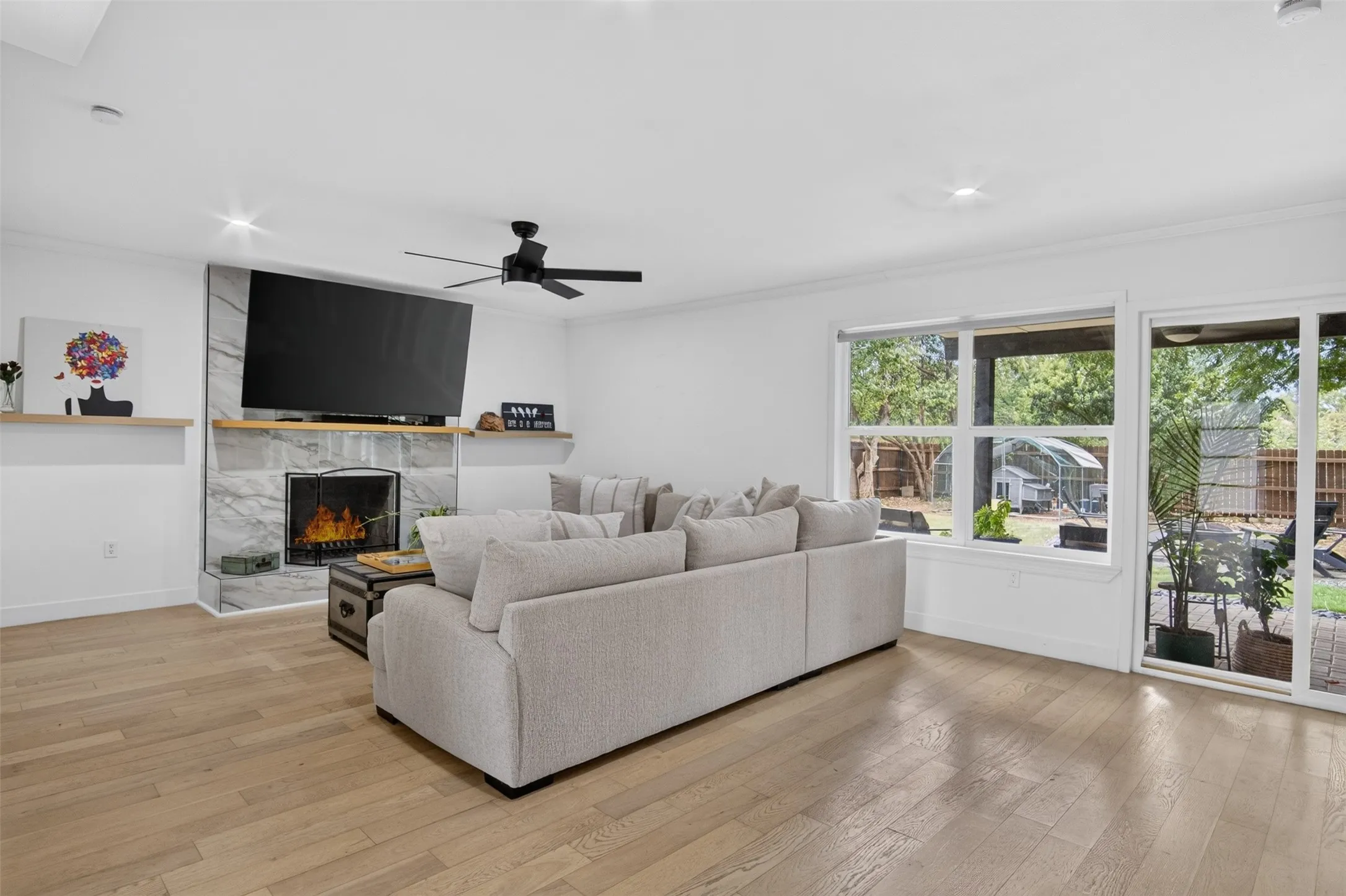 Living room with fireplace and view of yard.