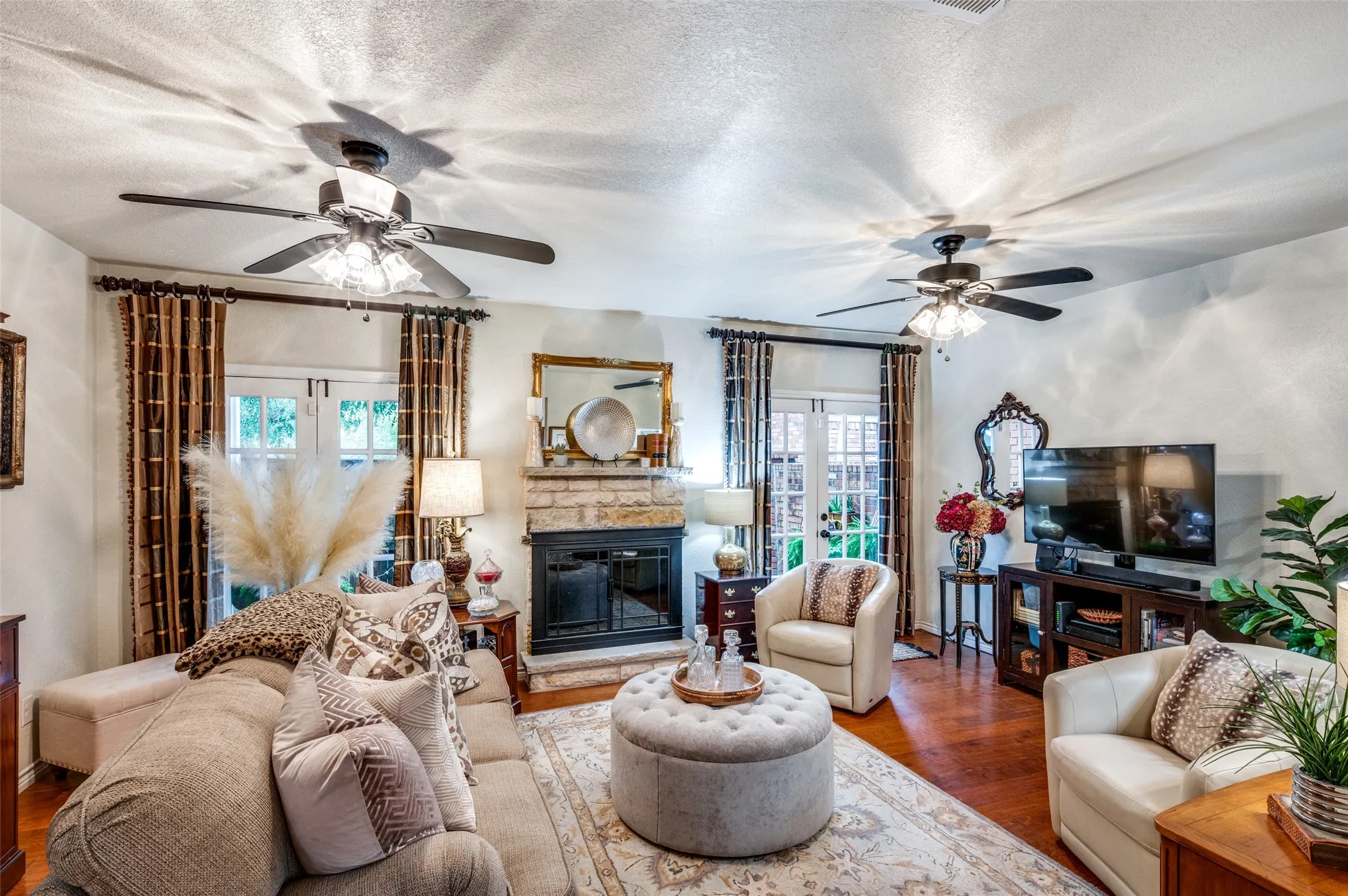 Living Room with Ceiling Fans, French Doors, and Fireplace