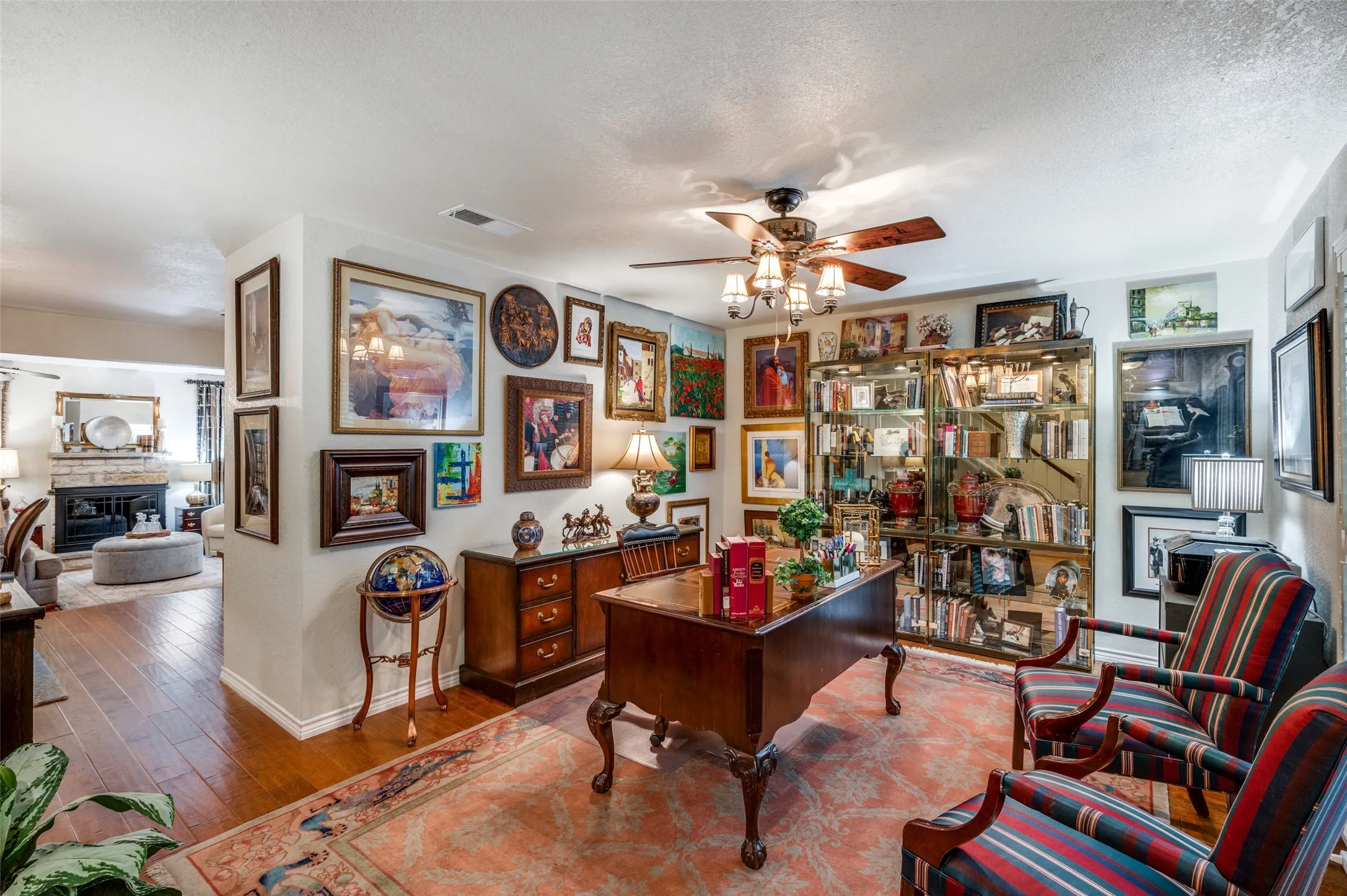 Dining Room or Home Office featuring Hardwood-style Plantation Shutters, Wood-style Flooring, and Ceiling Fan
