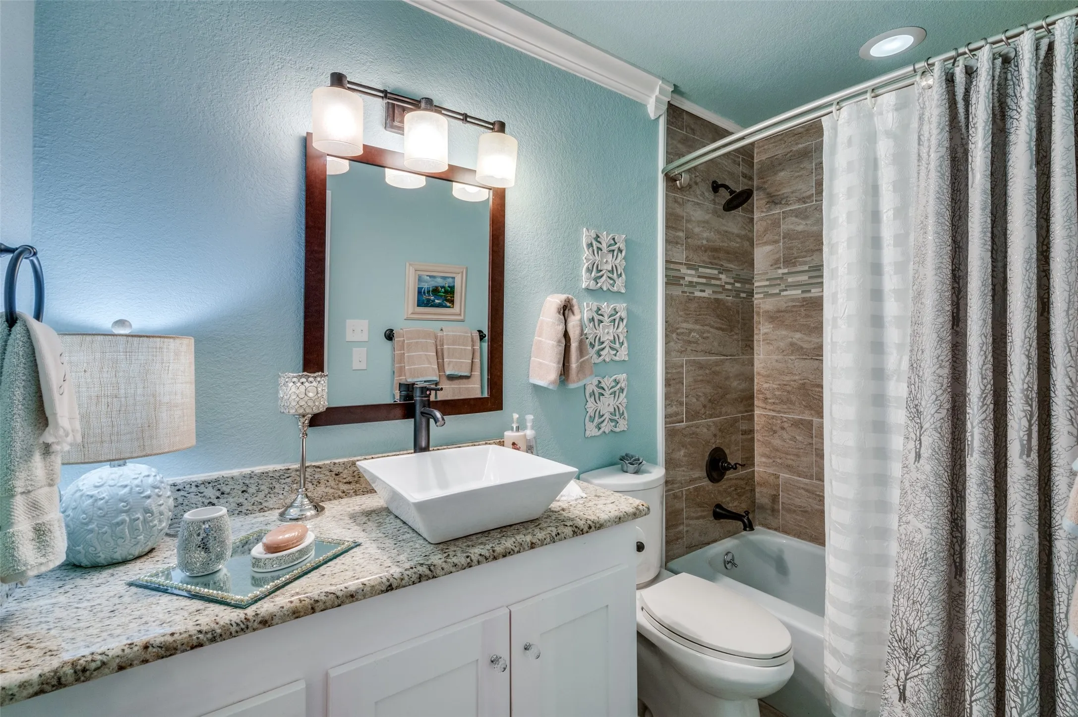 Full bathroom with shower / bath combination with curtain, toilet, and vanity