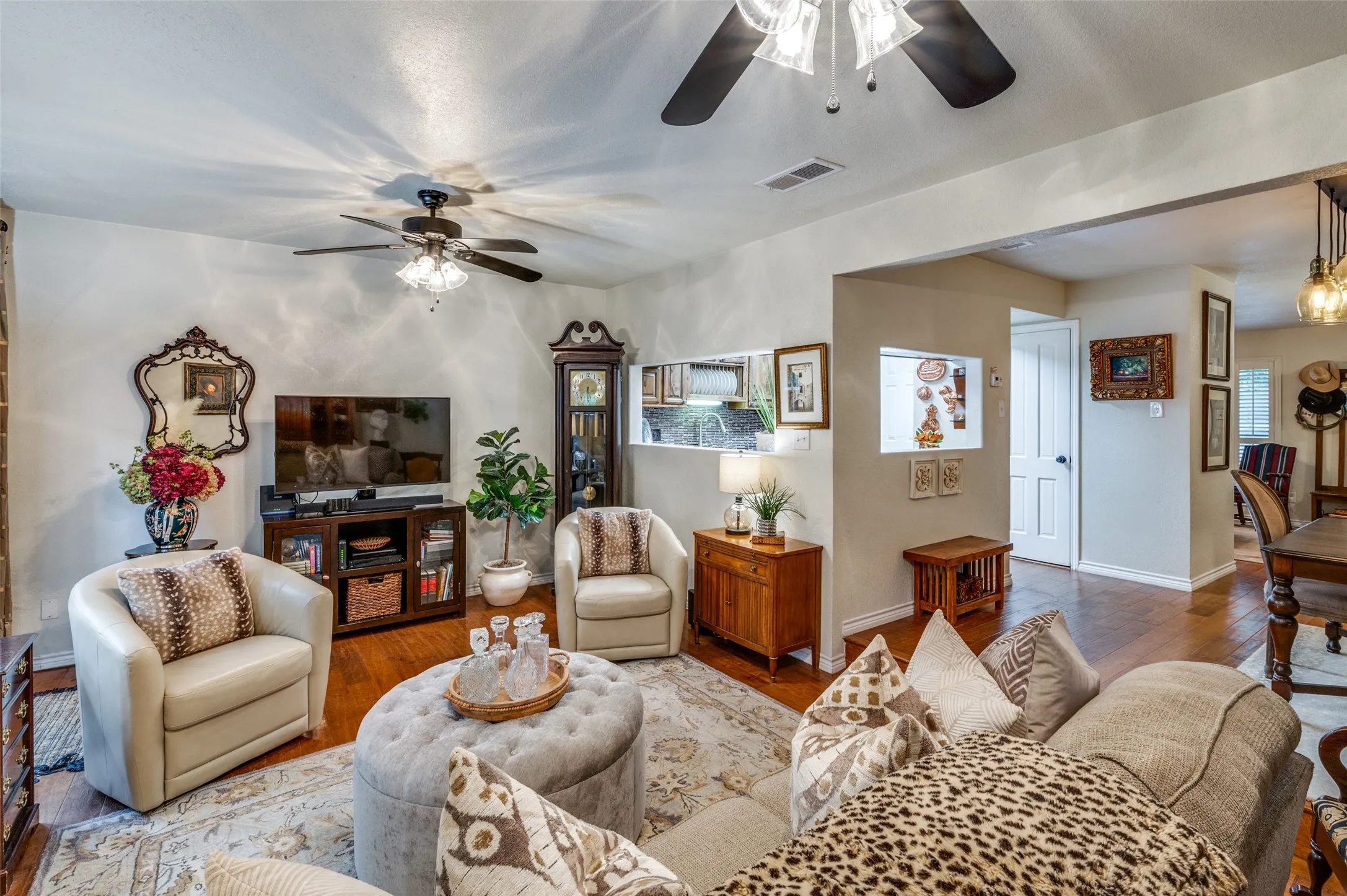 Living room featuring ceiling fans and wood-style flooring