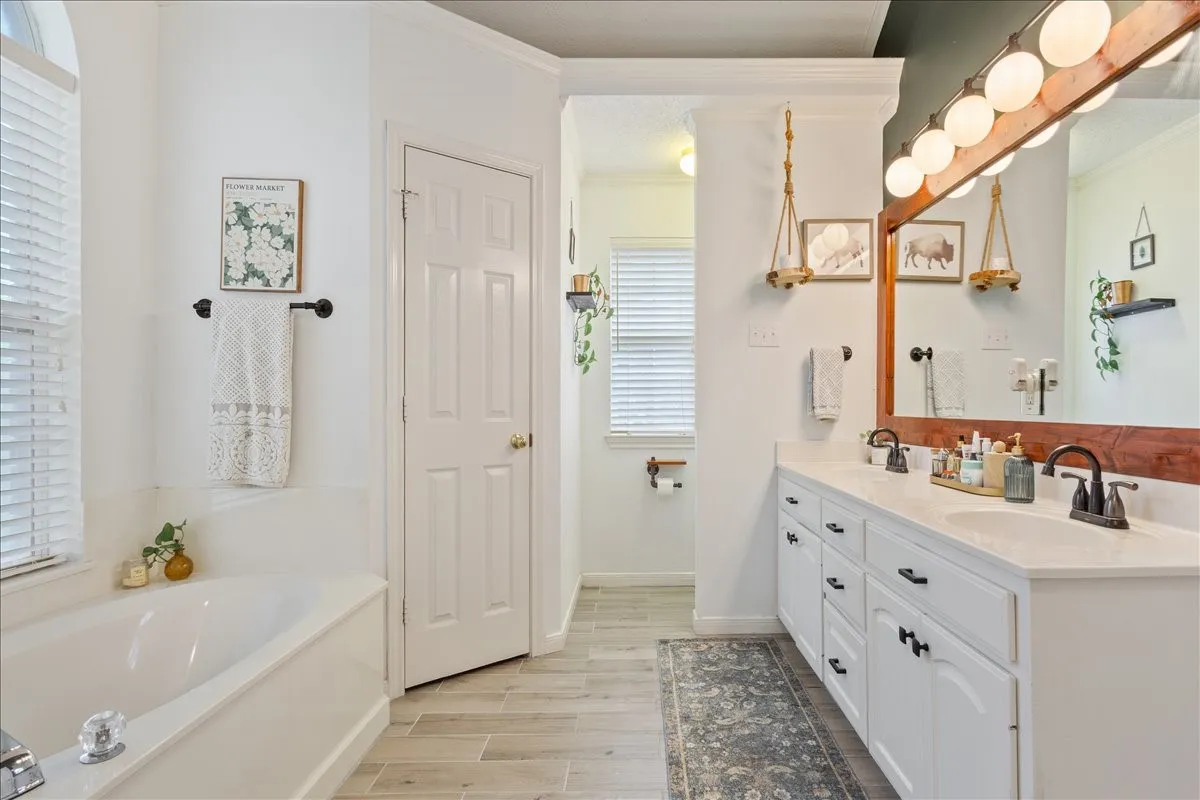 Dual vanity with white cabinetry and dark hardware