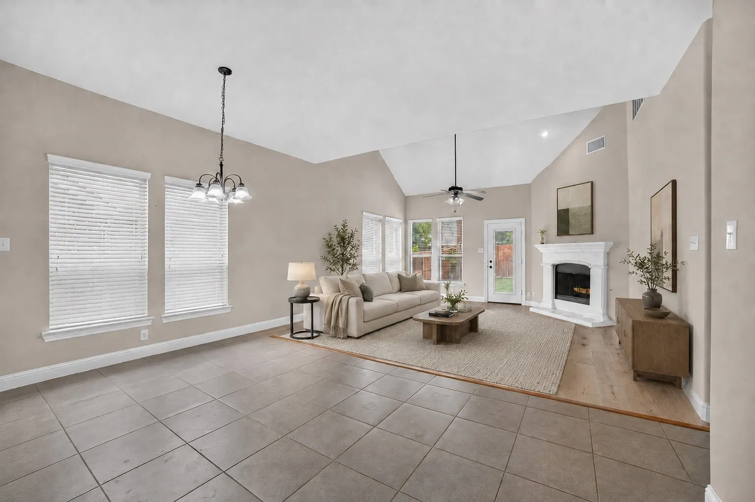 Spacious living area featuring a vaulted ceiling with recessed lighting and a ceiling fan